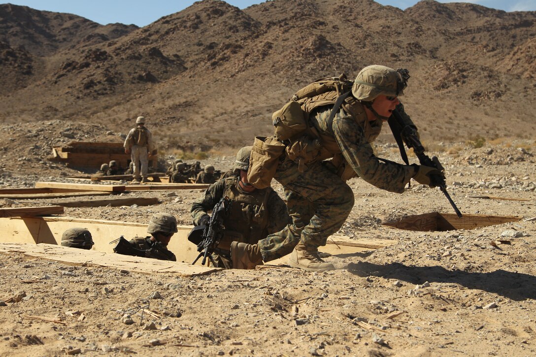 Students with the Infantry Officers’ Course charge from trench to trench during a live-fire training exercise at Range 410A March 15, 2012. The Combat Center is the last stop for this group of Marines during their training to officially become infantry officers.