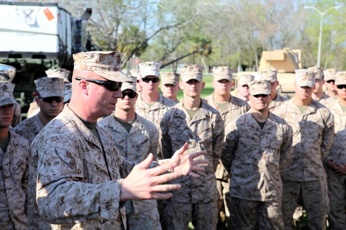 Lt. Col. Michael E. McWilliams (forefront), the commanding officer of Combat Logistics Battalion 8, 2nd Marine Logistics Group, speaks to Marines and sailors from the unit prior to a static display at Patriots Point Naval and Maritime Museum, Charleston Harbor, S.C., March 15, 2012. The troops had a chance to talk to visitors about some of the vehicles they drive, which included Logistics Vehicle System Replacements, Medium Tactical Vehicle Replacements, Mine Resistance Ambush Protected All-Terrain Vehicles and High Mobility Multipurpose Wheeled Vehicles. (Photo by Cpl. Bruno J. Bego)