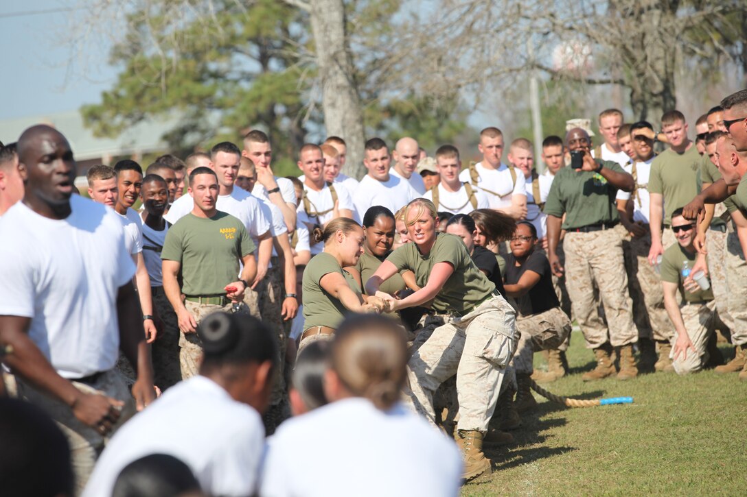 Marine spouses fall in formation behind their squad leader, Sgt.  Peter A. Suguitan, during the Marine Unmanned Aerial Vehicle Squadron 2 Jane Wayne Day March 15. Suguitan, an imagery analyst with the squadron, reported his squad to the commanding officer at the squadron’s headquarters building for the event, which more than 20 spouses attended.