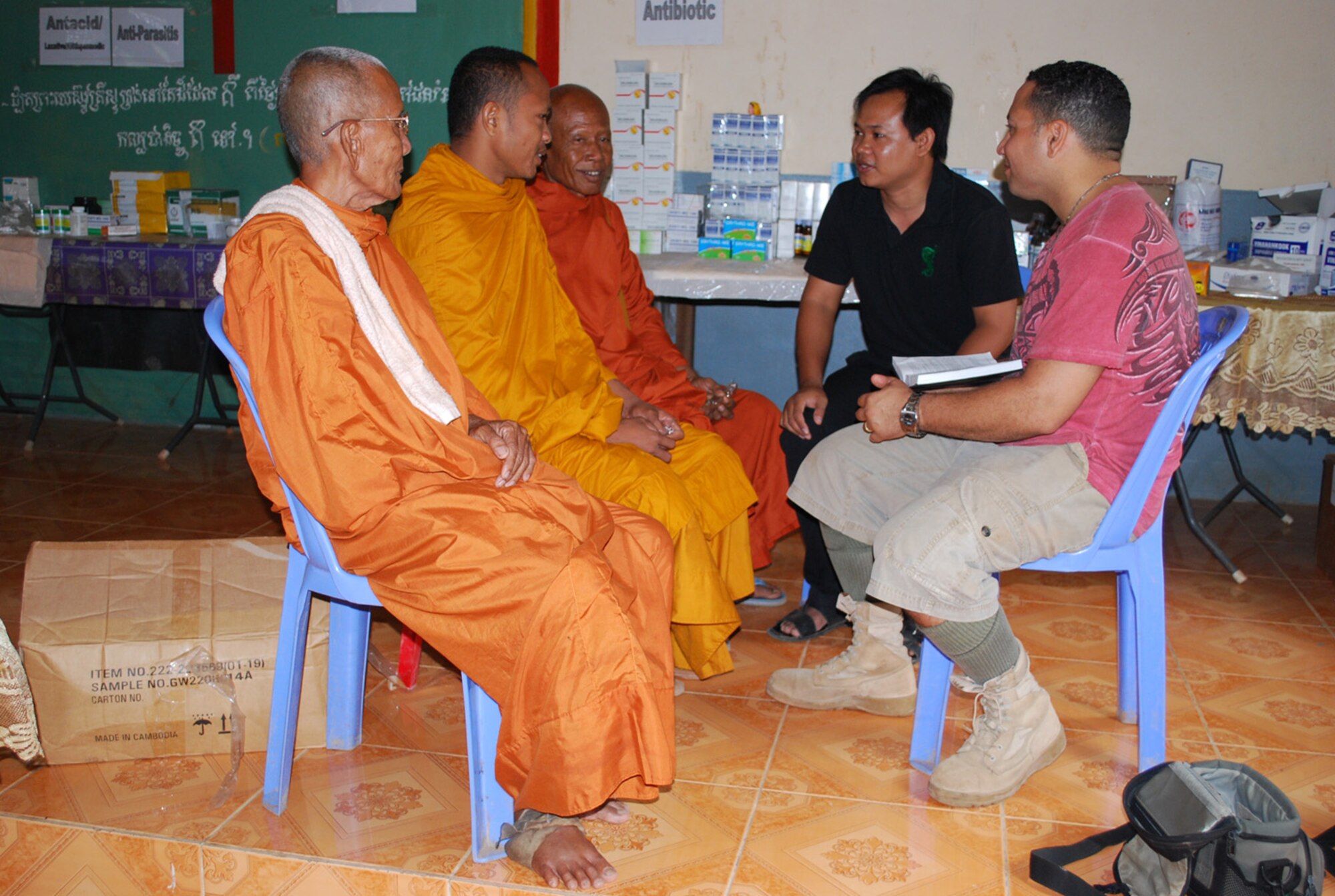 Chaplain (Capt.) Richard Rojas, 36th Wing Chapel, speaks with Buddhist monks during a chapel-sponsored mission trip to Cambodia in early February. Eleven Team Andersen members, including five active-duty Airmen, journeyed to the Southeast Asian country to provide spiritual,emotional and medical support to the men, women and children of Four Square Children of Promise, an orphanage in the Tumnup Village. After ten days, the team extracted 88 teeth, issued 492 pairs of perscription glasses, performed five surgeries and constructed a new kitchen. (U.S. Air Force coutesty photo)