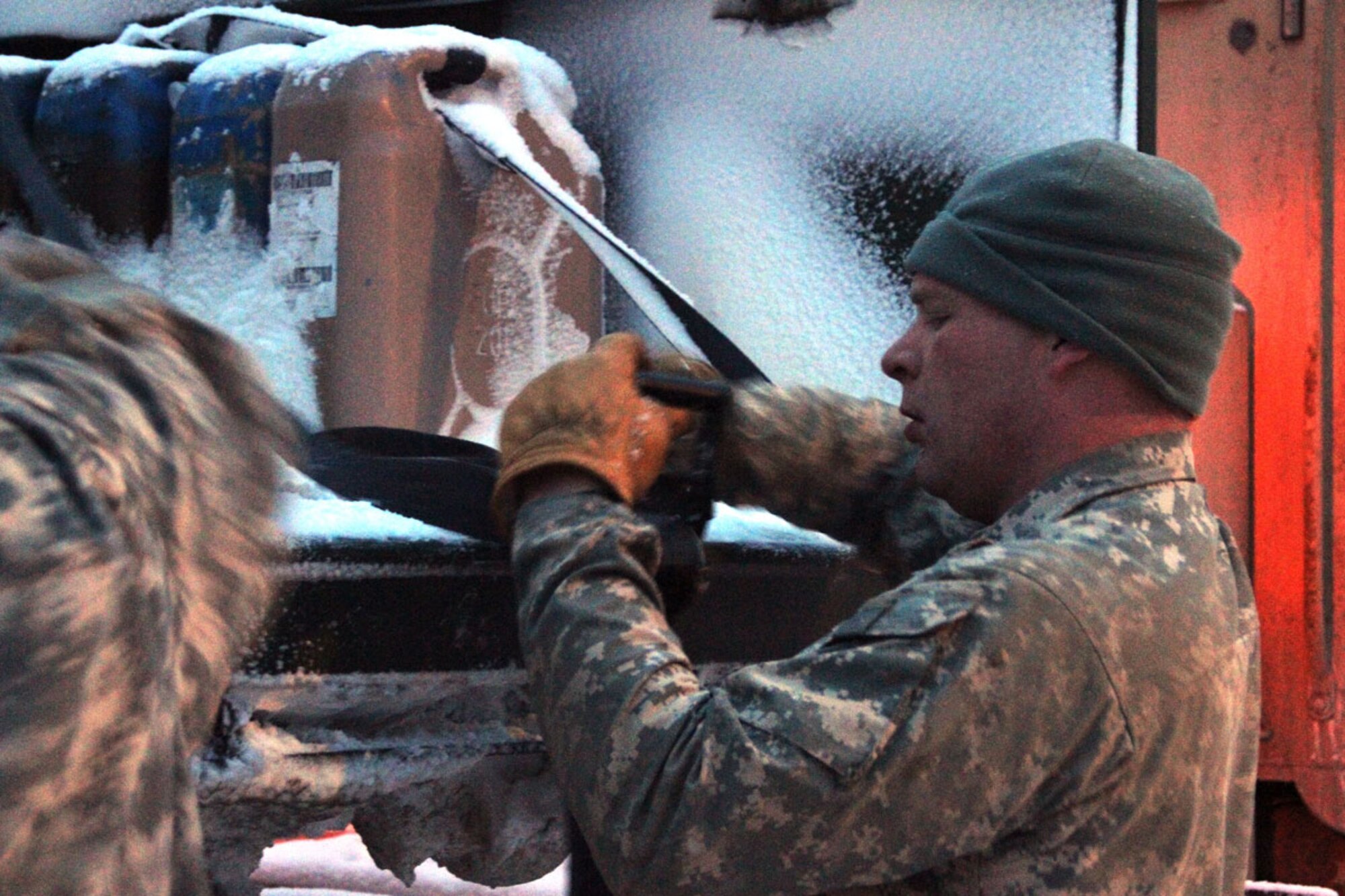 Sgt. Gilman Beito helps his teammates tie down a load near Fairbanks before heading back to Joint Base Elmendorf-Richardson during the weekly Operation Polar Express run Feb. 21.  (U.S. Army photo/Spc. Juana Nesbitt)