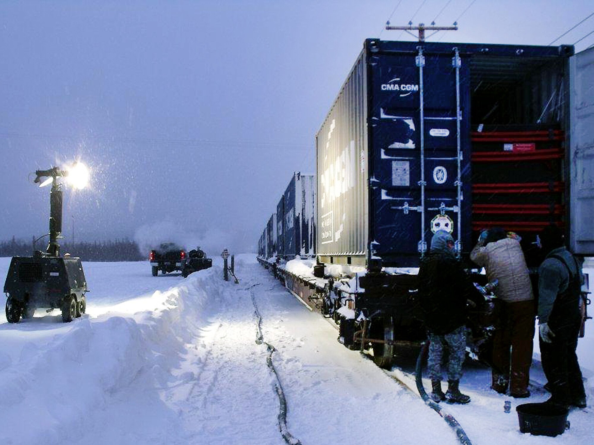 Icemen assigned to the 354th Civil Engineer Squadron liquid fuels maintenance section prepare flexi tanks for the transfer of deicer fluid Feb. 3, 2012, Eielson Air Force Base, Alaska. The team worked extended hours to ensure the proper transportation of 35 flexi tank fitters, specialized containers for the fluid, which were approved for transport and designed to resist the potential sloshing effect when in transit, especially when traveling by ocean liner and rail. (Courtesy photo)