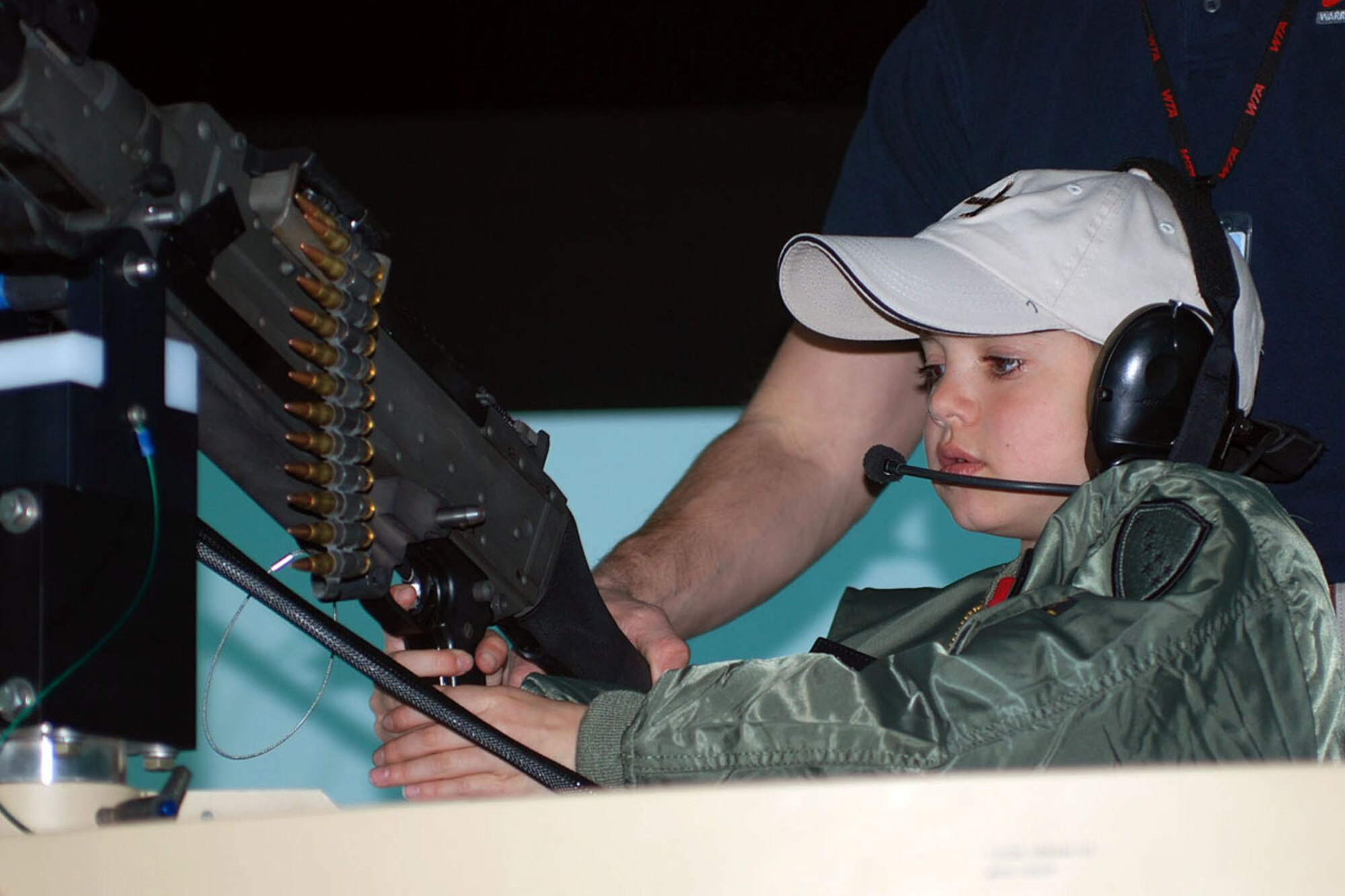 Nathan Rothe, a 9 year old with muscular dystrophy visiting the installation to experience the life of a Soldier for a day, operates the turret of a simulated military vehicle inside the reconfigurable vehicle tactical trainer at the Mission Training Complex on Joint Base Elmendorf-Richardson. (Photo by Staff Sgt. Matthew E. Winstead/U.S. Army Alaska Public Affairs)