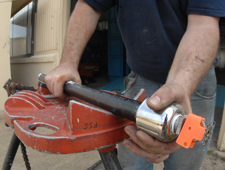 David Hudson, Fire and Sprinkler Services installer, mounts a sprinkler head to a branch line at the 2nd Maintenance Squadron structural maintenance coating shop on Barksdale Air Force Base, La., March 14. The branch line and sprinkler head are the final pieces that need to be connected to complete the installation inside and on top of the paint booth. (U.S. Air Force photo/Airman 1st Class Joseph A. Pagán Jr.)(RELEASED)