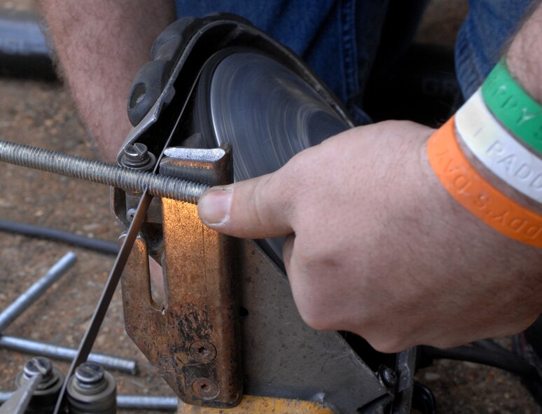 David Hudson, Fire and Sprinkler Services installer, cuts a hanger at the 2nd Maintenance Squadron structural maintenance coating shop on Barksdale Air Force Base, La., March 12. Hudson cut a hanger to hold a branch line from the ceiling for a sprinkler system. (U.S. Air Force photo/Airman 1st Class Joseph A. Pagán Jr.)(RELEASED)