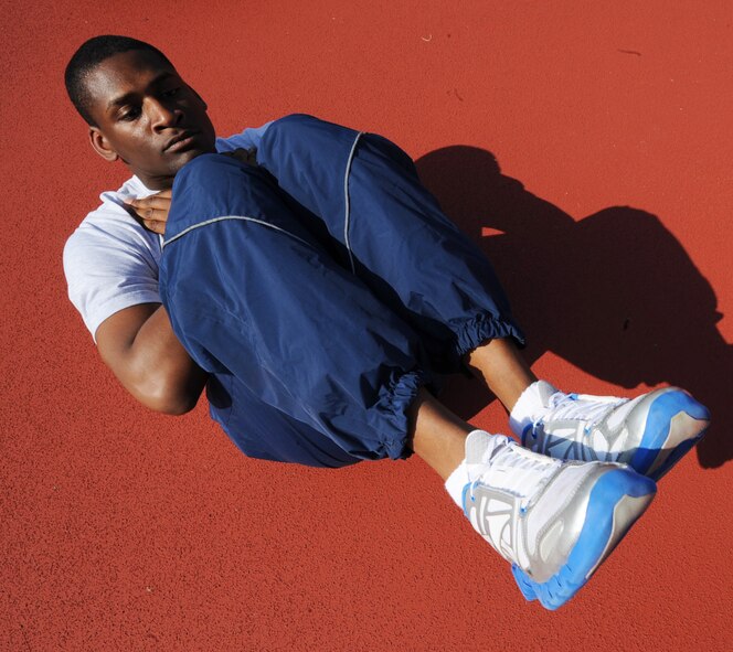 U.S. Air Force Airman 1st Class Percy Mitchell III performs sit-ups during a physical training session on Seymour Johnson Air Force Base, N.C., March 14, 2012. Practicing different aspects of a physical training test leads to better performance and helps increase PT scores. Mitchell, 4th Communications Squadron, is a native of Philadelphia. (U.S. Air Force photo/Airman 1st Class Aubrey Robinson/Released)