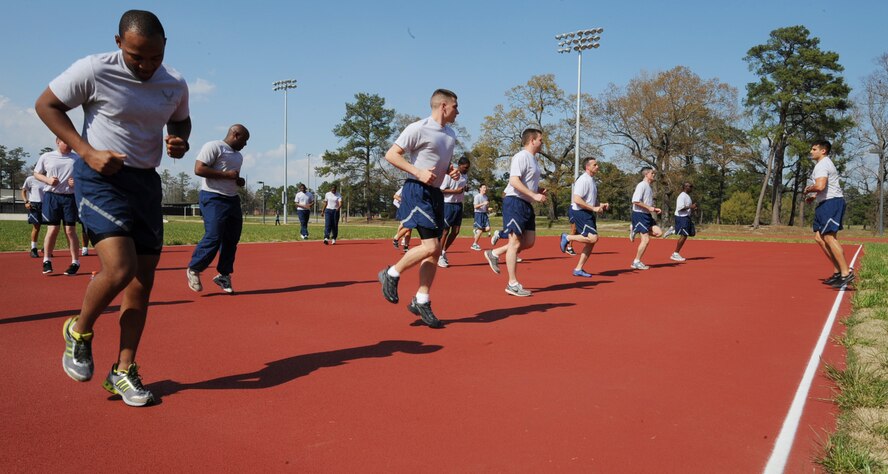 Airmen from the 4th Communications Squadron run in place during a physical training session on Seymour Johnson Air Force Base, N.C., March 14, 2012. Exercising as a group helps Airmen build camaraderie through teamwork. (U.S. Air Force photo/Airman 1st Class Aubrey Robinson/Released)