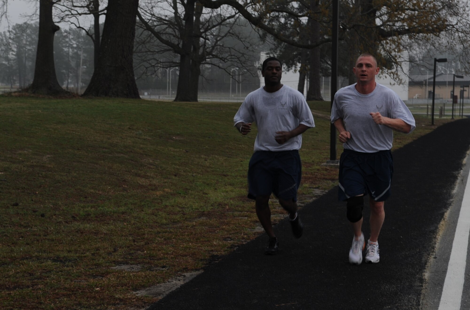 U.S. Air Force Staff Sgt. Brandon Riggins and Tech. Sgt. Jason Jessee finish a squadron run on Seymour Johnson Air Force Base, N.C., March 14, 2012. Airmen assigned to the 4th Civil Engineer Squadron run more than 4 miles every other Wednesday in order to support the 4th Fighter Wing’s increased fitness goals. Riggins, 4th CES Fire Protection Flight, hails from St. Paul, N.C. Jessee, 4th CES Fire Protection Flight, hails from Winter Springs, Fla. (U.S. Air Force photo/Airman 1st Class Aubrey Robinson/Released)