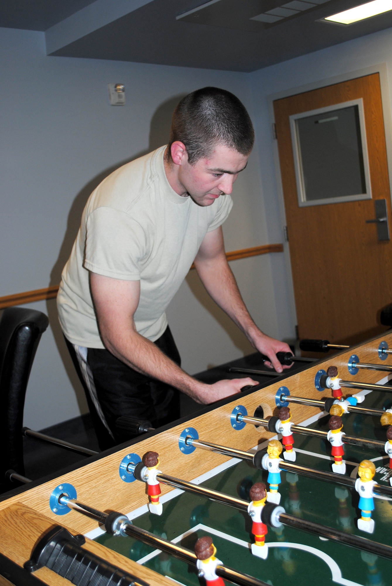 Airman 1st Class Tyler Johnson, 341st Logistics Readiness Squadron traffic management cargo apprentice and a first-term Airman, enjoys a game of foosball in a the game room of one of Malmstrom's dormitories.  (U.S. Air Force photo/Airman 1st Class Katrina Heikkinen)