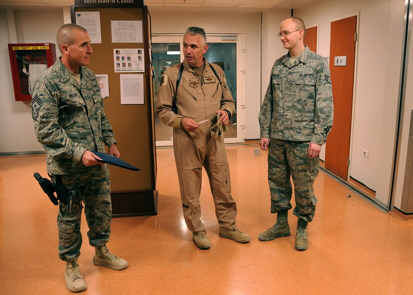 After calling Staff Sgt. Jonathan Shields, 341st Medical Support Squadron medical laboratory technician; right, in front of other members deployed to Kandahar Air Base, Afghanistan, Chief Master Sgt. Thomas Valley, 451st Air Expeditionary Wing command chief, and Brig. Gen. Scott Dennis, 451st AEW commander, prepare to award Shields with a promotion to technical sergeant. Shields' promotion was awarded on behalf of Col. H.B. Brual, 341st Missile Wing commander, through the Stripes for Exceptional Performers program. (U.S. Air Force courtesy photo)