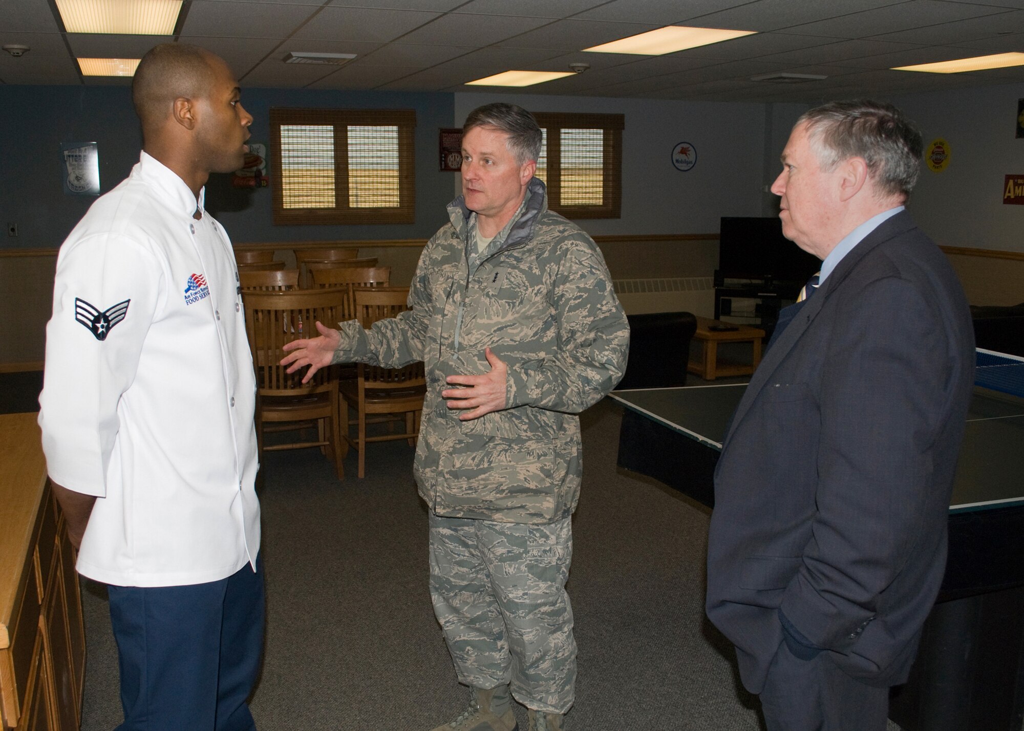 Lord and Senior Executive Service member James Clark, director of intelligence, surveillance and reconnaissance innovations and deputy chief of staff for ISR Headquarters Air Force, speak with Senior Airman Michael Jordan, 12th Missile Squadron missile chef, at a Missile Alert Facility about chef duties in the missile field. (U.S. Air Force photo/Beau Wade)