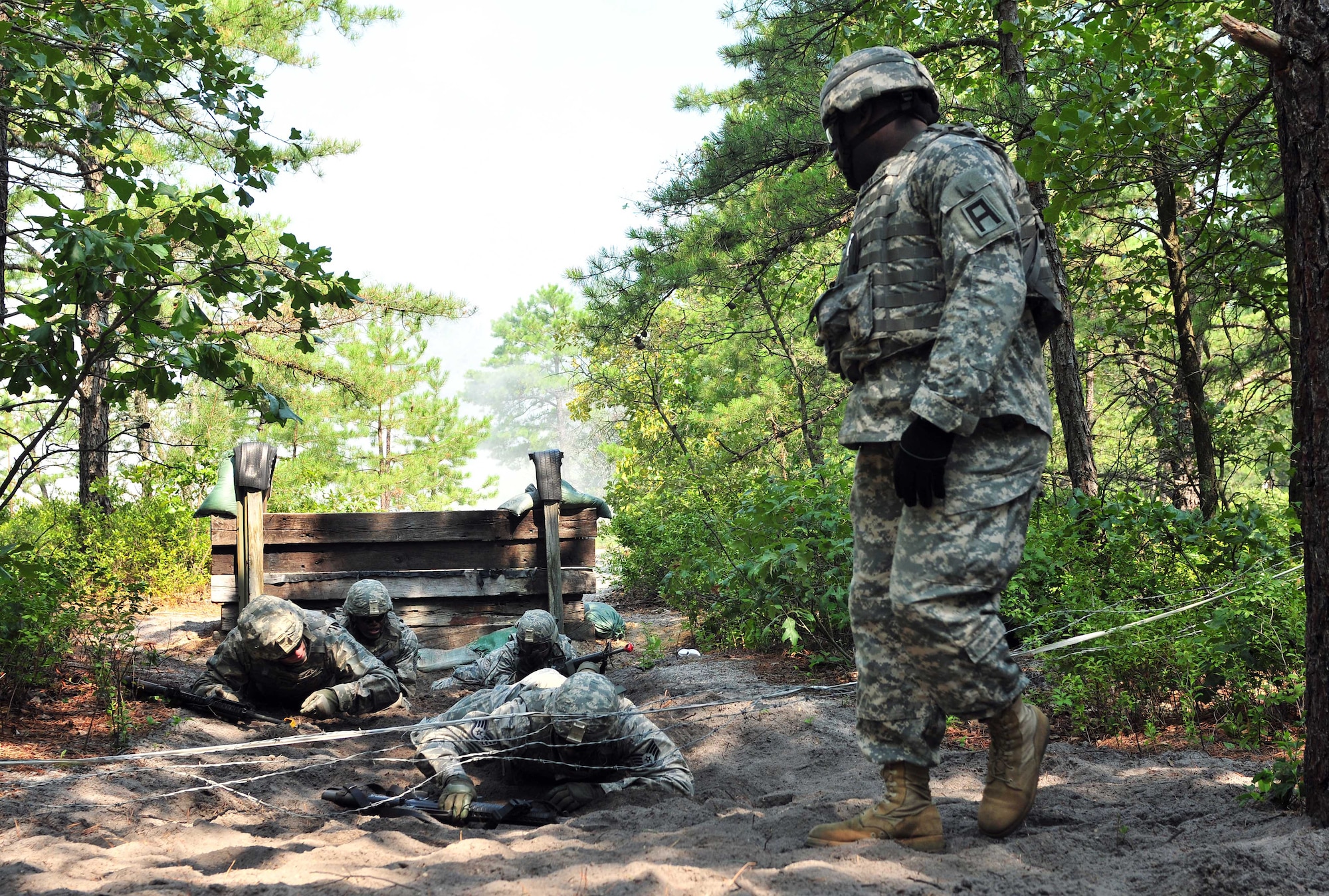 Service members crawl under obstacles while conducting pre-mobilization training with trainer mentors from First Army Division East at Joint Base McGuire-Dix-Lakehurst, N.J. (U.S. Air Force photo by Staff Sgt. Amburr Reese/Released)