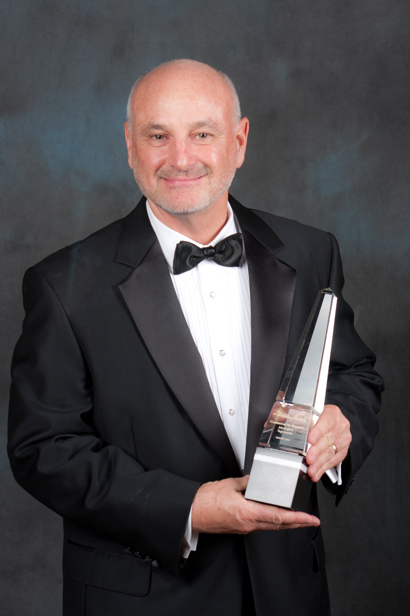 Dave Madden, director of the Military Satellite Communications Systems Directorate,  poses with the 2012 Aviation Week Laureate Award, during the 55th Annual Laureate Awards ceremony, held March 7, in Washington D.C.  