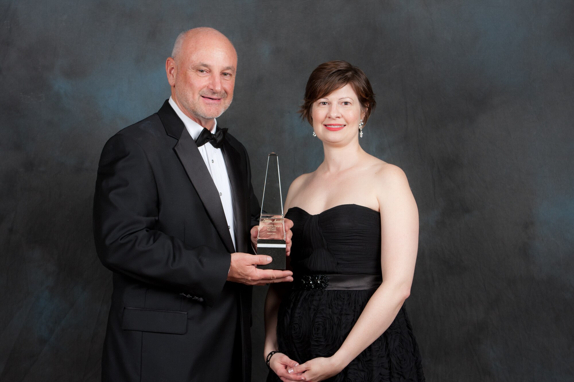 Dave Madden, director of the Military Satellite Communications Systems Directorate, and Amy Butler, senior Pentagon editor for Aviation Week & Space Technology, pose with the 2012 Aviation Week Laureate Award, during the 55th Annual Laureate Awards ceremony, held March 7, in Washington, D.C.  Madden accepted the award on behalf of the Advanced Extremely High Frequency Flight-1 Recovery Team.  The team was honored for their successful planning and execution of an innovative 14-month orbit raising campaign, and mission-saving recovery of the $1.7 billion, first-of-its-kind AEHF-1 satellite. Photo courtesy of Aviation Week.

