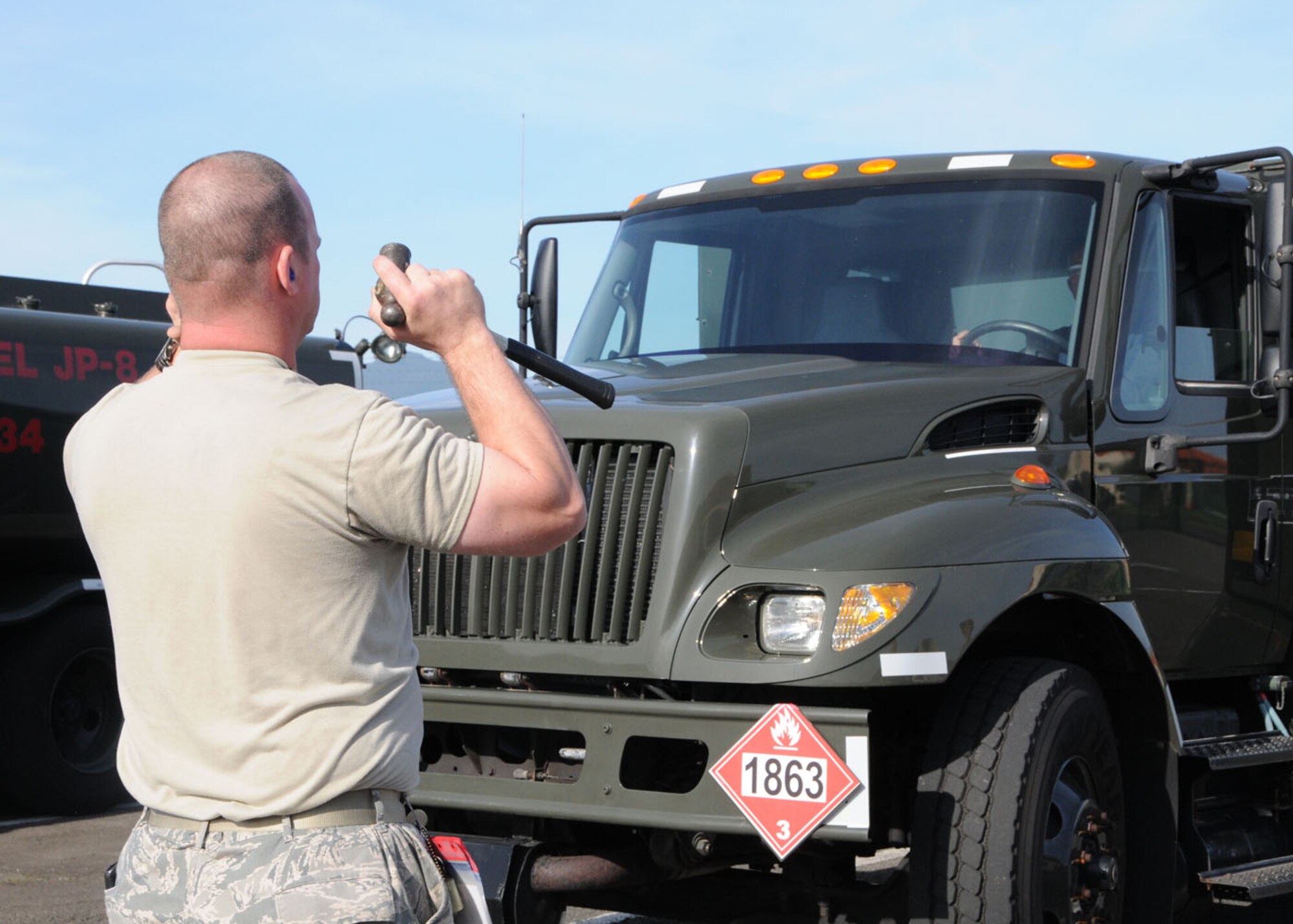 Staff Sgt. Jason Swanson, 65th Logistics Readiness Squadron refueling maintenance supervisor, directs a fuel truck in the parking lot before performing daily maintenance check, March 13, 2012. (U.S. Air Force photo/Tech. Sgt. Chyrece Campbell)
