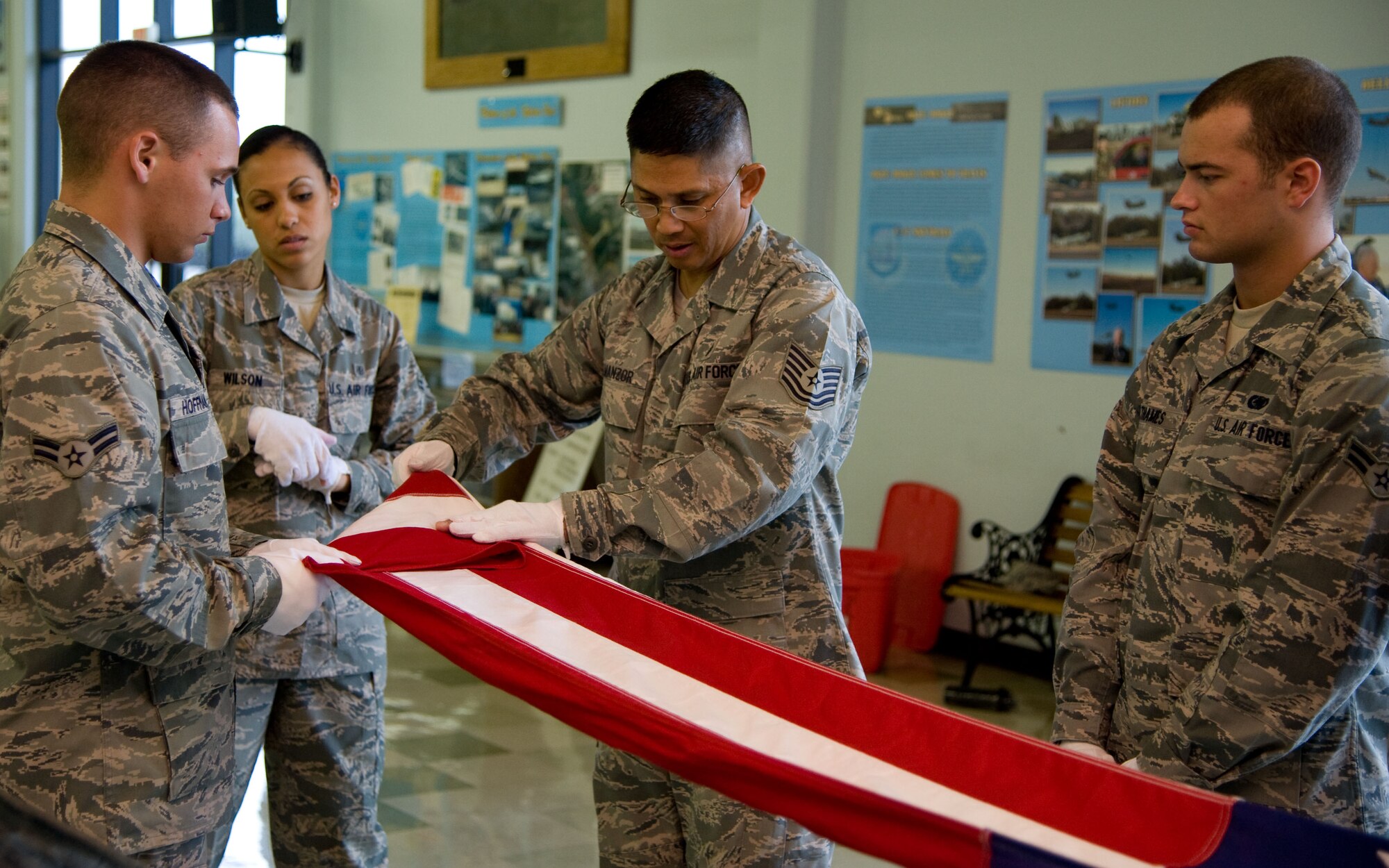 Tech. Sgt. Tony Almanzor, 349th Aerospace Medicine squadron, shows the new Honor Guard class how to properly fold the flag during a funeral at the Travis Air Museum Tuesday. (U.S. Air Force photo/Airman 1st Class Nicole Leidholm)