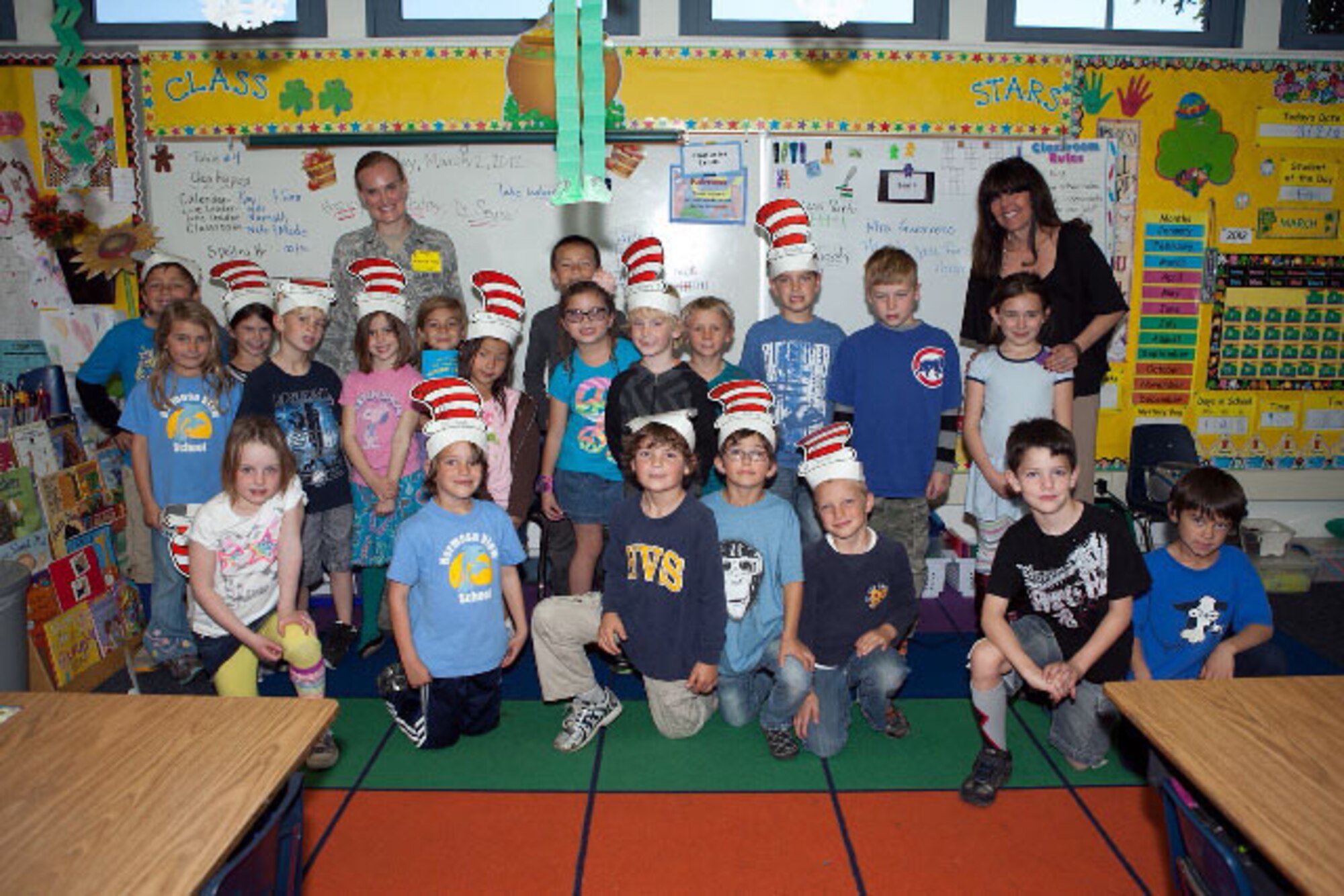 1st Lt. Kristin Hoover poses for a group picture with Mrs. Ramirez's first grade class during Read Across America at Hermosa View Elementary School, Hermosa Beach, Calif. Photo courtesy of Military Satellite Communications Systems Directorate.