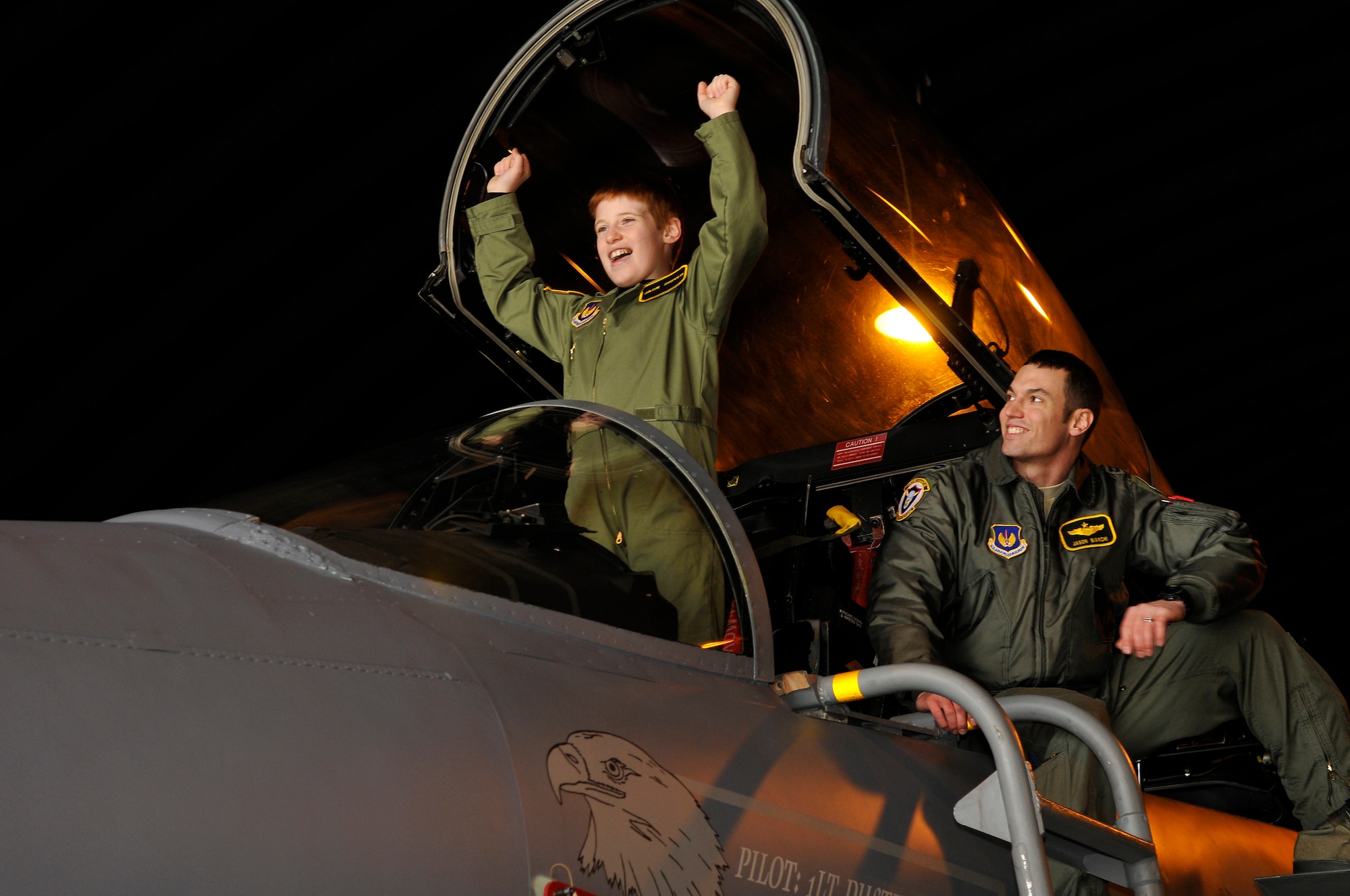 ROYAL AIR FORCE LAKENHEATH, England -- Jack Driver, 10, celebrates about getting in an F-15C Eagle aircraft with Capt. Jason Bianchi, 493rd Fighter Squadron pilot, on the RAF Lakenheath flightline March 14, 2012.  Driver, who suffers from Aplastic Anemia, a rare auto immune disorder where bone marrow fails to make enough blood cells, was selected as a pilot for the day.  The Pilot for a Day program is new to RAF Lakenheath and provides children in the local community, who are fighting life-threatening illnesses or conditions, a day of fun as well as a break from the routine doctor and hospital visits. (U.S. Air Force photo by Staff Sgt. Connor Estes)