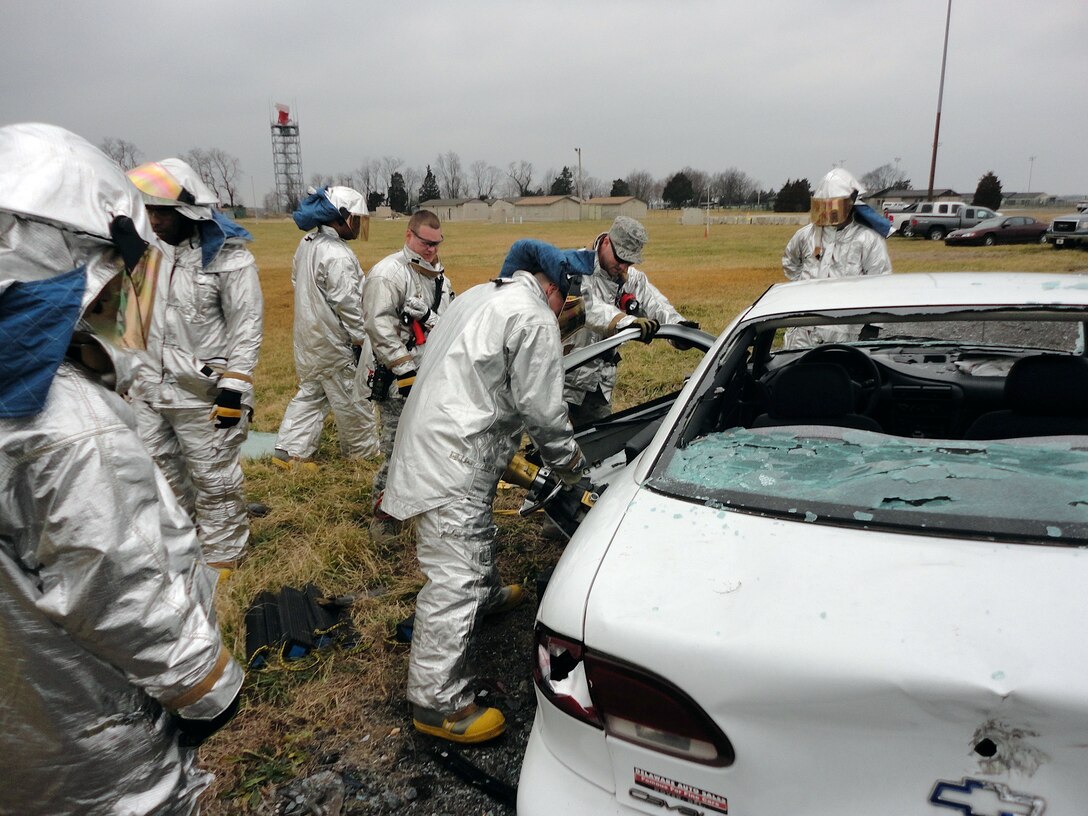 Firefighters, from the 512th Civil Engineer Squadron, participate in auto extrication training Feb. 4, 2012, on Dover Air Force Base, Del. AET is a required annual proficiency training requirement for Air Force firefighters. (U.S. Air Force courtesy photo) 