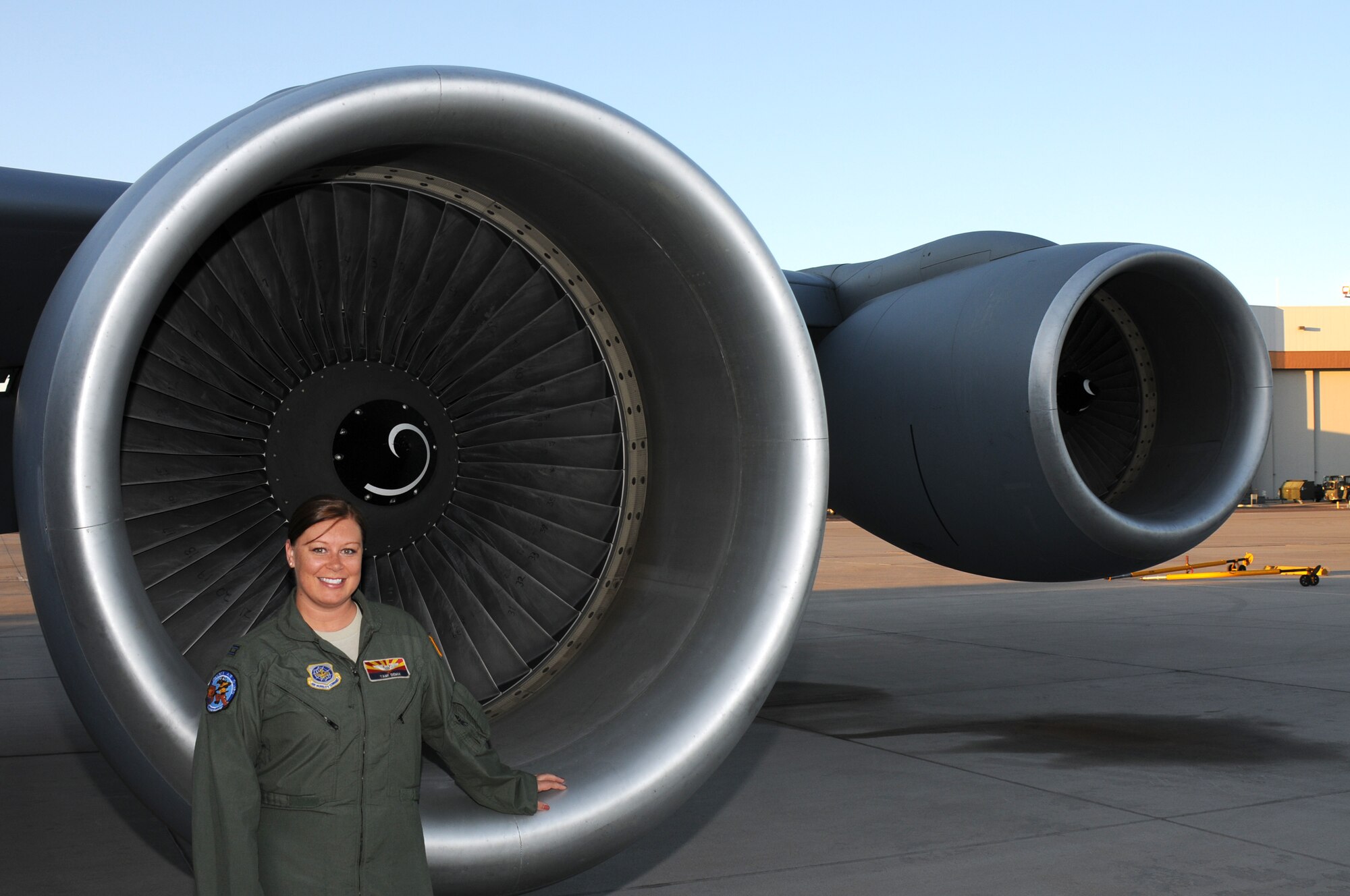 Capt. Tamela Demik, 161st Operations Group, chief of current operations, stands next to an engine of a KC-135 Stratotanker March 15, 2012, at the 161st Air Refueling Wing, Phoenix. Captain Demik is one of four female pilots currently assigned to the 161 ARW. (U.S. Air Force photo by Staff Sgt. Michael Matkin/Released)