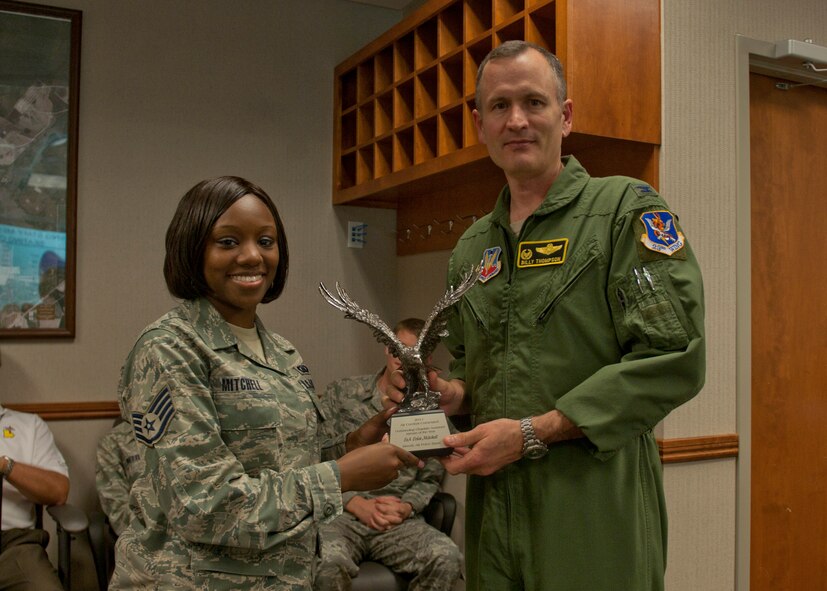 U.S. Air Force Staff Sgt. Erica Mitchell, 23d Wing chaplain assistant, is presented with the 2011 Air Combat Command Outstanding Chaplain Assistant Airman of the Year award by Col. Billy Thompson, 23d Wing commander, at Moody Air Force Base, Ga., March 14, 2012. Mitchell was recognized for her outstanding performance during her deployment to Bagram, Afghanistan from Jan. – Aug. of 2011, and now competes for the same award at the Air Force level. (U.S. Air Force photo by Senior Airman Eileen Meier/Released) 