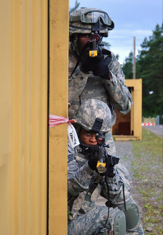 SEMBACH AIR BASE, Germany – Staff Sgt. Ashley Tyler, bottom, 100th Security Forces Squadron, performs building clearing during mobile military operation on urban terrain training at Sembach Air Base, Germany, in July 2011, prior to her deployment to Baghdad, Iraq. Tyler was the squad and team leader for exercises during MOUT training, and said she was the smallest and shortest of the team. She is an evaluator in the 100th SFS and is a native of Baton-Rouge, La. (U.S. Air Force photo by Senior Airman Patrick Sainvil)