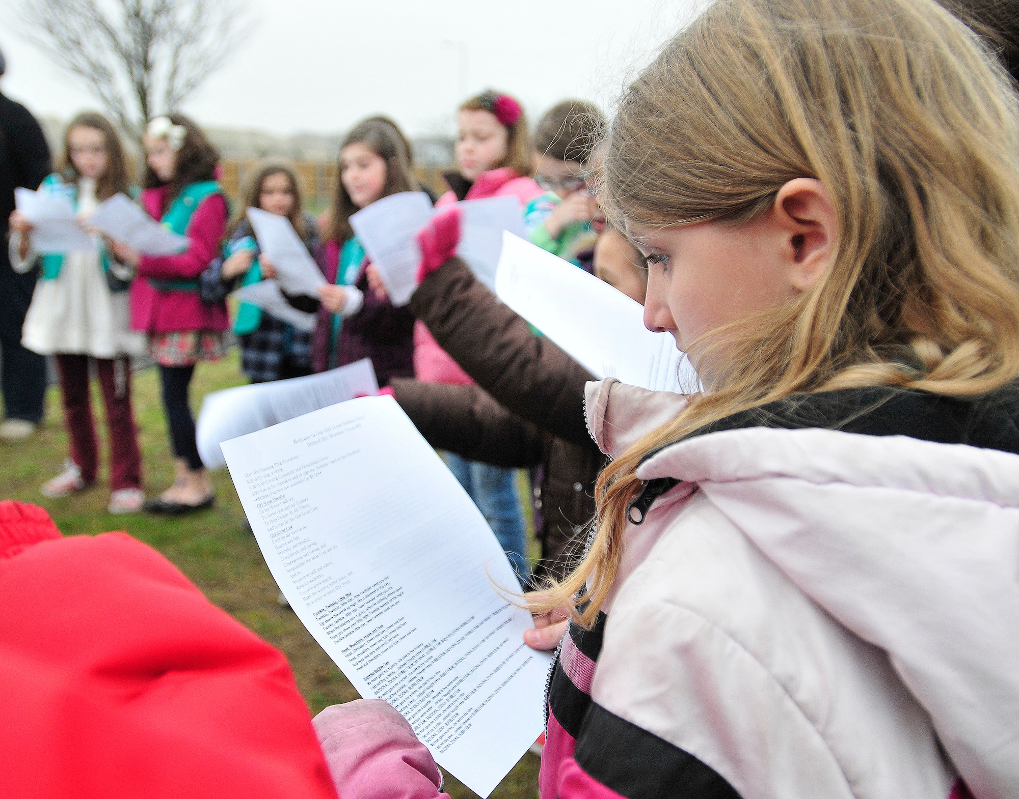 ROYAL AIR FORCE LAKENHEATH, England - Rebekah Cox, Junior Girl Scout Troop 01, sings along with other girls during the Girl Scouts' 100th Birthday event at Defender's Park March 12, 2012. The event, planned by the members of Anglia Brownie Troop 43, included a group sing-along, friendship circle, cupcakes and fun. (U.S. Air Force photo by Senior Airman Tiffany M. Deuel)