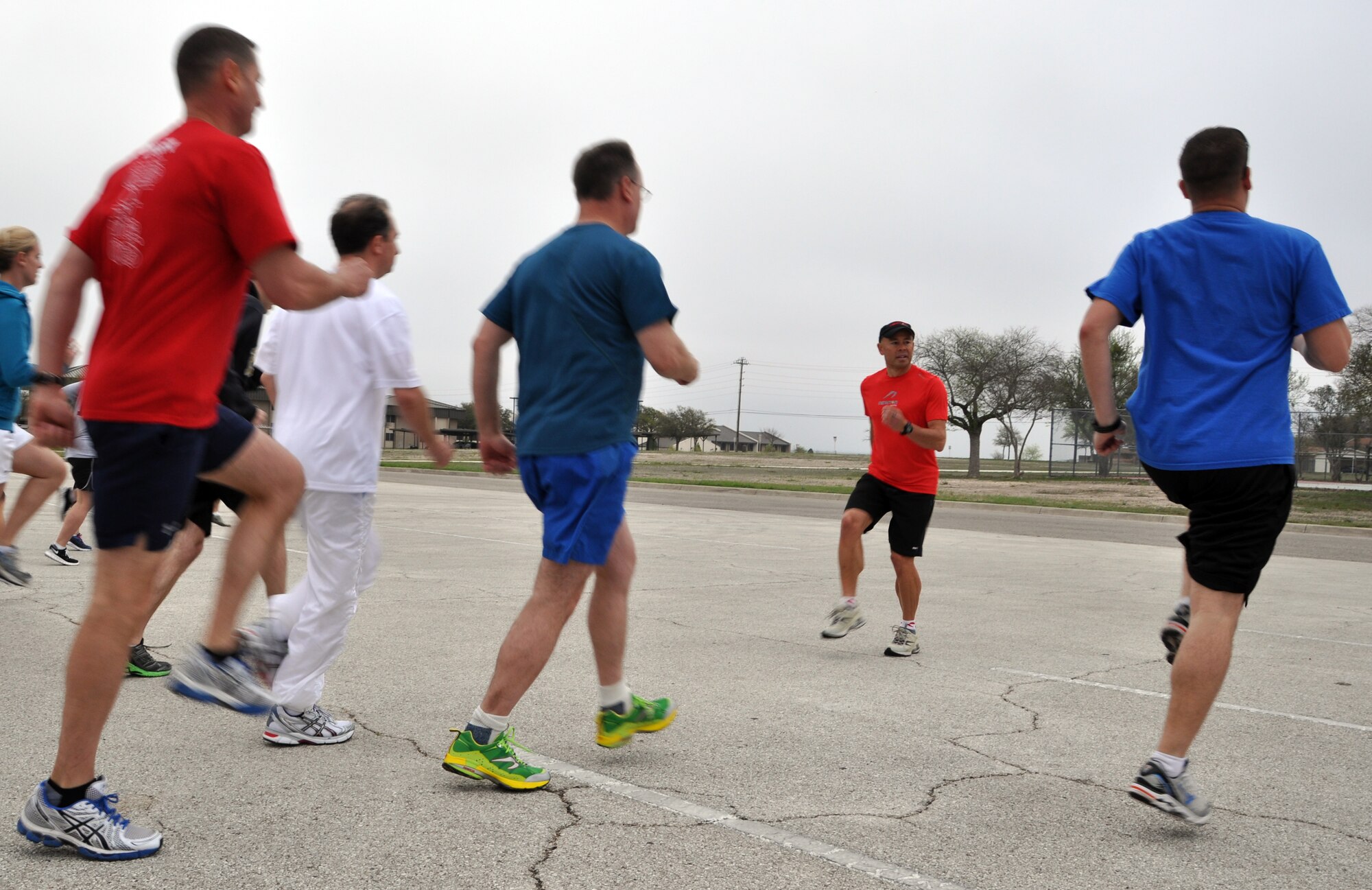 LAUGHLIN AIR FORCE BASE, Texas— Seven-time world champion adventure racer Ian Adamson leads runners in a natural running drill in the Club XL parking lot here March 13. Adamson hosted a one-and-a- half day clinic to teach everything from the advantages of a natural running gait to the characteristics of good running shoes. (U.S. Air Force photo/2nd Lt. James Ramirez)