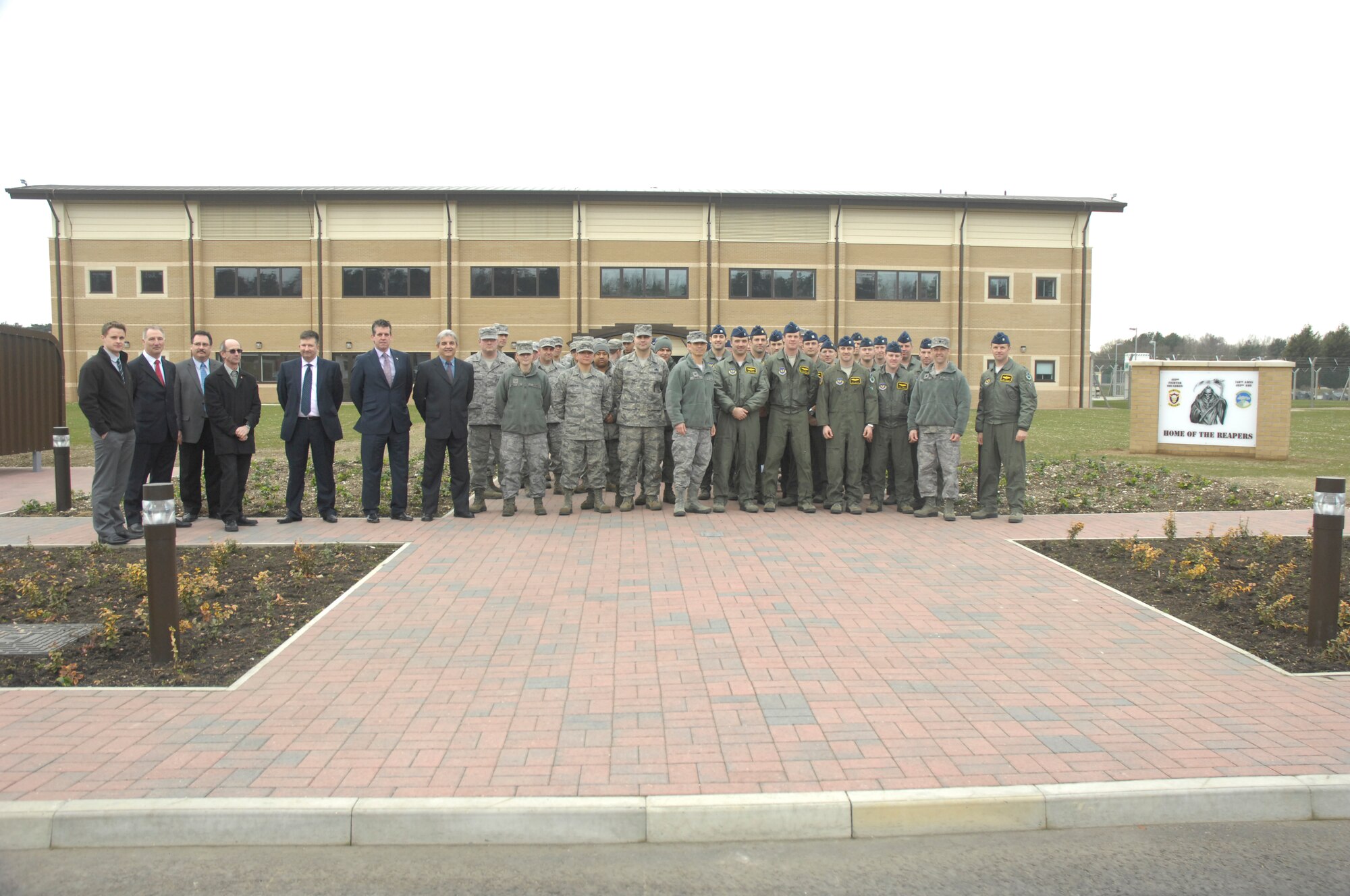 ROYAL AIR FORCE LAKENHEATH, England – Members of the 48th Operations Group, 48th Maintenance Group and defense contractors stand before the newly completed 493rd Fighter Squadron Operations and Aircraft Maintenance building March 9, 2012. The construction of the building started in July 2010 and was officially turned over to the 48th Fighter Wing March 9, 2012. (U.S. Air Force photo by Senior Airman Amanda Wowk) 