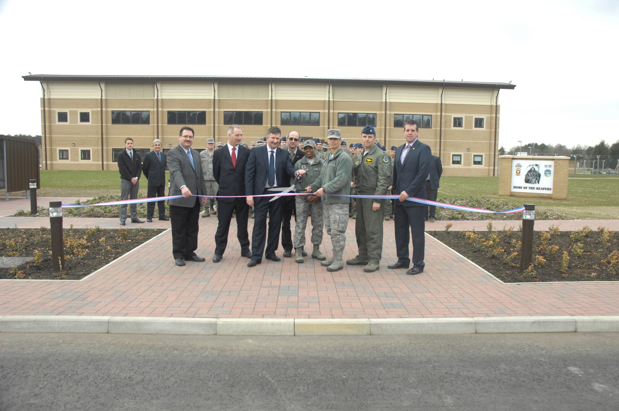 ROYAL AIR FORCE LAKENHEATH, England – (from left) Juan Perez, Air Force Center for Engineering and Environment chief, John Claydon and Dennis Cotton, Kier Eastern prime contractors, Roger Martin, Defense Infrastructure Organization, Lt. Col. Argie Moore, 748th Aircraft Maintenance Squadron commander, Col. John Quintas, 48th Fighter Wing commander, Lt. Col. Lendy Renegar, 493rd Fighter Squadron director of operations, and Nigel McCurdy, 48th Civil Engineer Squadron honorary commander, prepare to cut the ribbon signifying the completion of the 493rd FS Operations and Aircraft Maintenance building March 9, 2012. The construction of the building started in July 2010 and was officially turned over to the 48th FW March 9, 2012. (U.S. Air Force photo by Senior Airman Amanda Wowk)