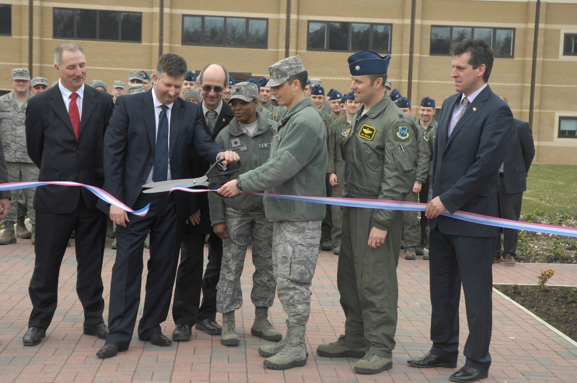 ROYAL AIR FORCE LAKENHEATH, England – Dennis Cotton, Kier Eastern prime contractor, and Col. John Quintas, 48th Fighter Wing commander, cut the ribbon signifying the completion of the 493rd Fighter Squadron Operations and Aircraft Maintenance building March 9, 2012. The construction of the building started in July 2010 and was officially turned over to the 48th Fighter Wing March 9, 2012. (U.S. Air Force photo by Senior Airman Amanda Wowk)
