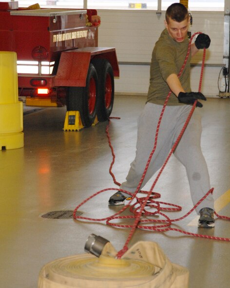 Senior Airman David Kelly, a fire fighter with the 178th Civil Engineer Squadron does the fire hoserope pull as part of the fire fighter's cicuit training March 4.at the Springfield Ohio Air National Guard base.
The fire hose rope pull was part of a 15 minute, five station circuit program that is conducted on Unit 