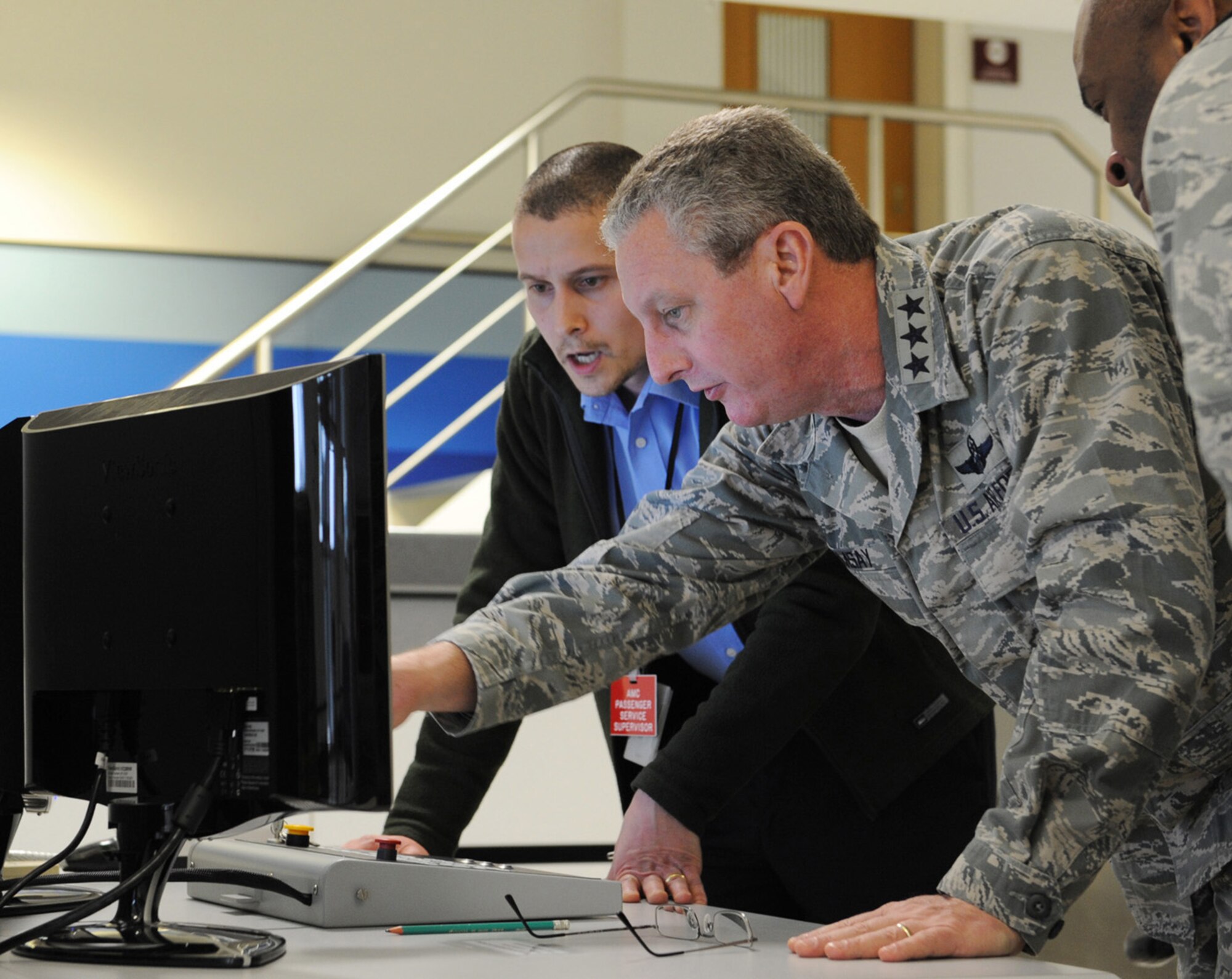RAF MILDENHALL, England -- Lt. Gen. Mark F. Ramsay, 18th Air Force commander, examines an X-ray display with the assistance of James Berry, 727th Air Mobility Squadron shift supervisor, at the passenger terminal here March 13, 2012. Ramsay spent two days at the base meeting Airmen and Ministry of Defence personnel. (U.S. Air Force photo/Tech. Sgt. Neal X. Joiner)