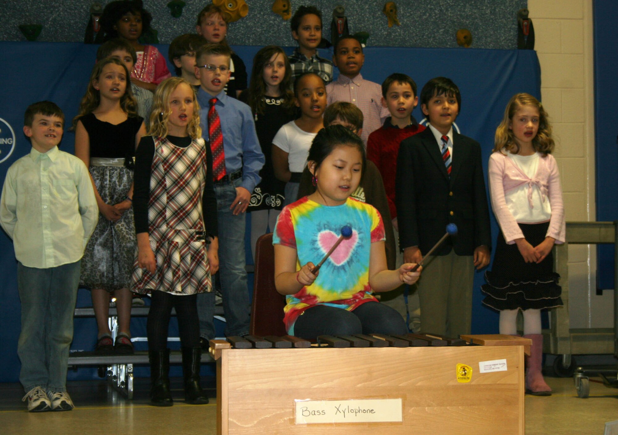 HANSCOM AIR FORCE BASE, Mass. - Melissa Chen plays the bass xylophone with Mrs. Johnson's class behind her during the Winter Concert at the Hanscom Primary School. Second and third grade students recently sang, played the xylophones and danced to a variety of musical compositions for approximately 200 family members and friends. (Courtesy photo)