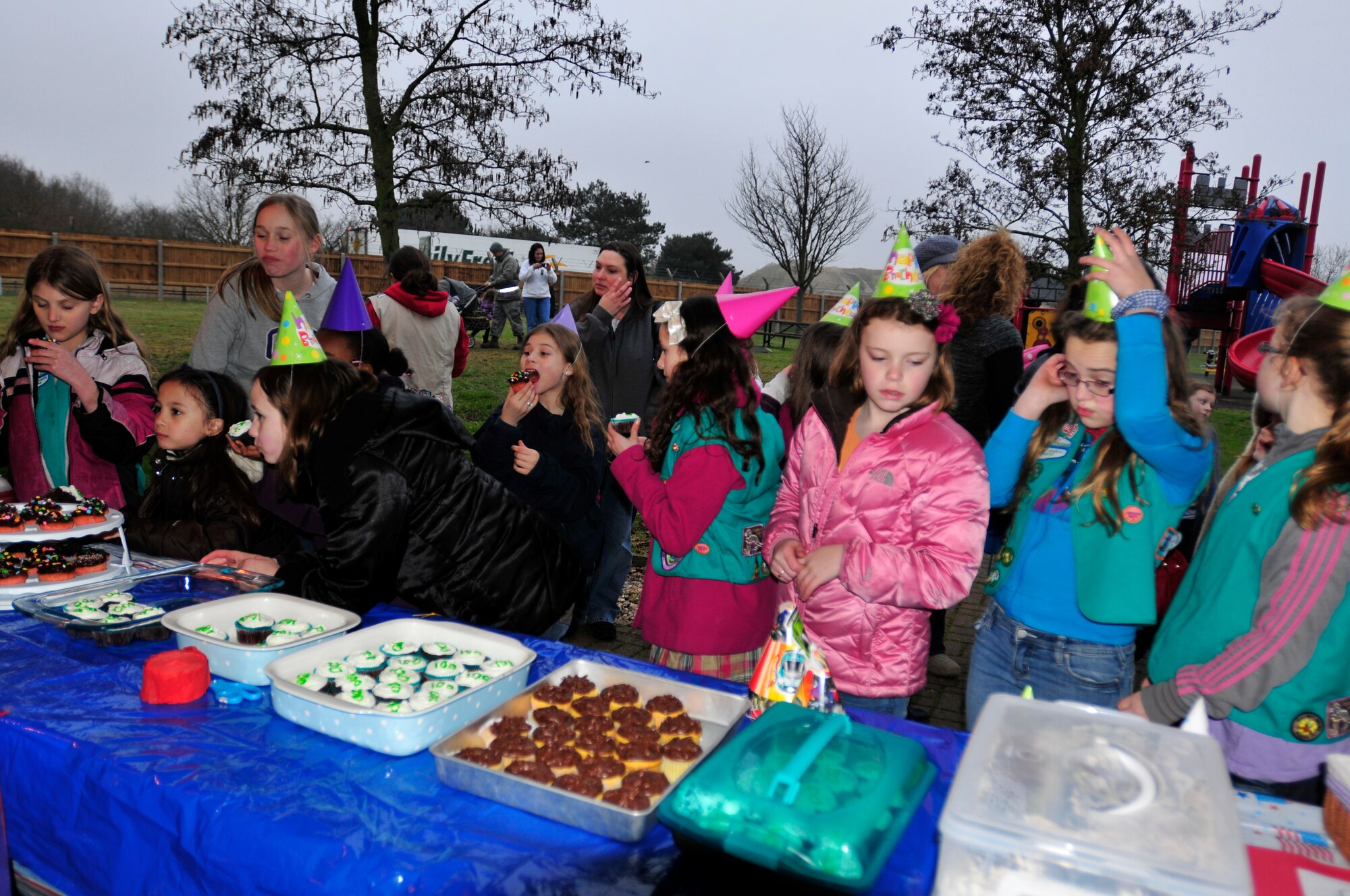 ROYAL AIR FORCE LAKENHEATH, England - Girls enjoy cupcakes during the Girl Scouts' 100th Birthday event at Defender's Park March 12, 2012. The event, planned by the members of Anglia Brownie Troop 43, included a group sing-along, friendship circle, cupcakes and fun. (U.S. Air Force photo by Senior Airman Tiffany M. Deuel)
