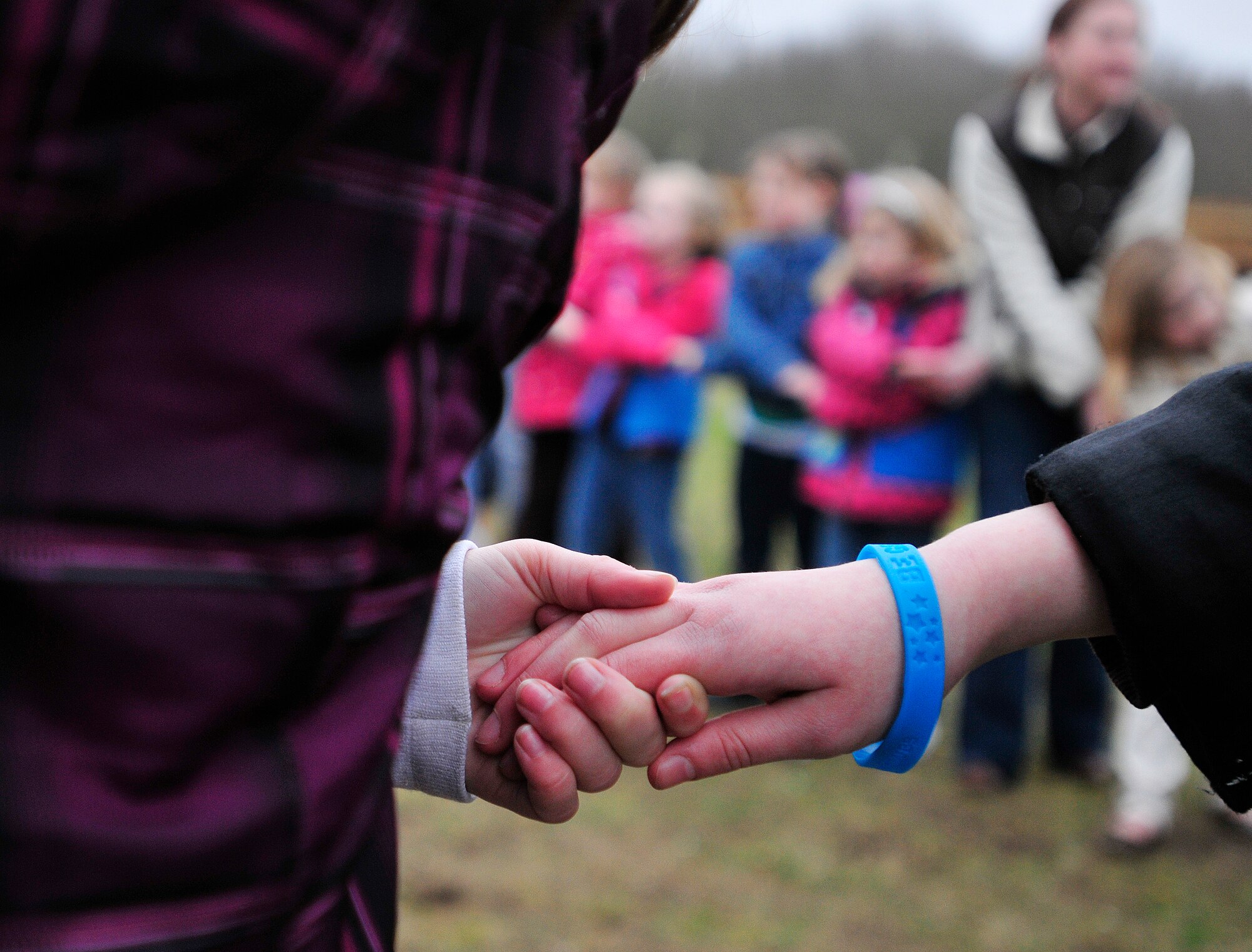 ROYAL AIR FORCE LAKENHEATH, England - Girls perform a friendship circle during the Girl Scouts' 100th Birthday event at Defender's Park March 12, 2012. The event, planned by the members of Anglia Brownie Troop 43, included a group sing-along, friendship circle, cupcakes and fun. (U.S. Air Force photo by Senior Airman Tiffany M. Deuel)