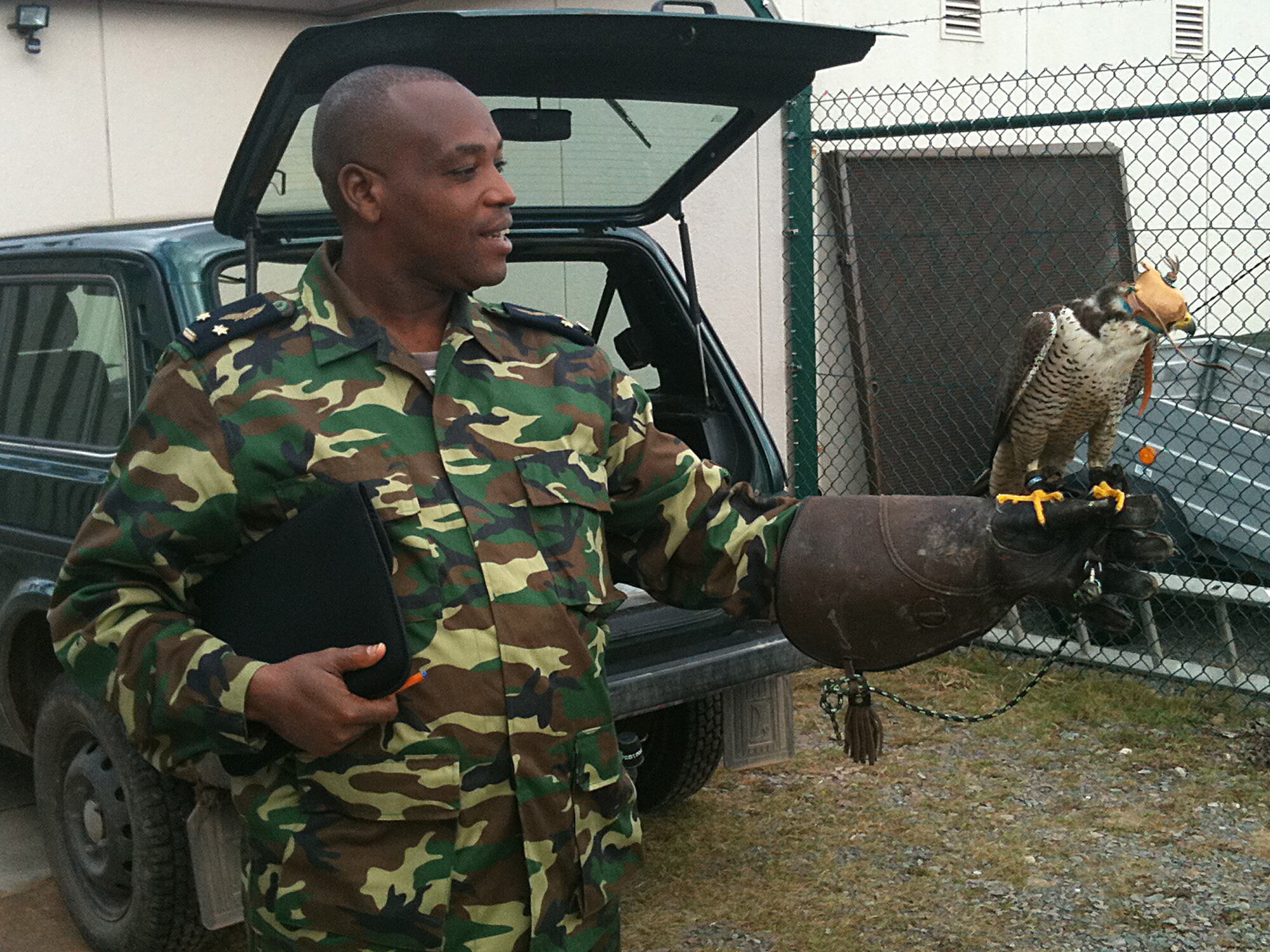 Burundian air force Lt. Col. Prime Yamuremye, holds a falcon used for the Bird Aircraft Strike Hazard flight safety program during a visit toRamstein Air Base, Germany, March 8, 2012. Four Burundian air force members came to Ramstein to get familiarized with the airfield, ground and flight-safety programs the U.S. Air Force uses. (U.S. Air Force photo/Staff Sgt. Travis Edwards)