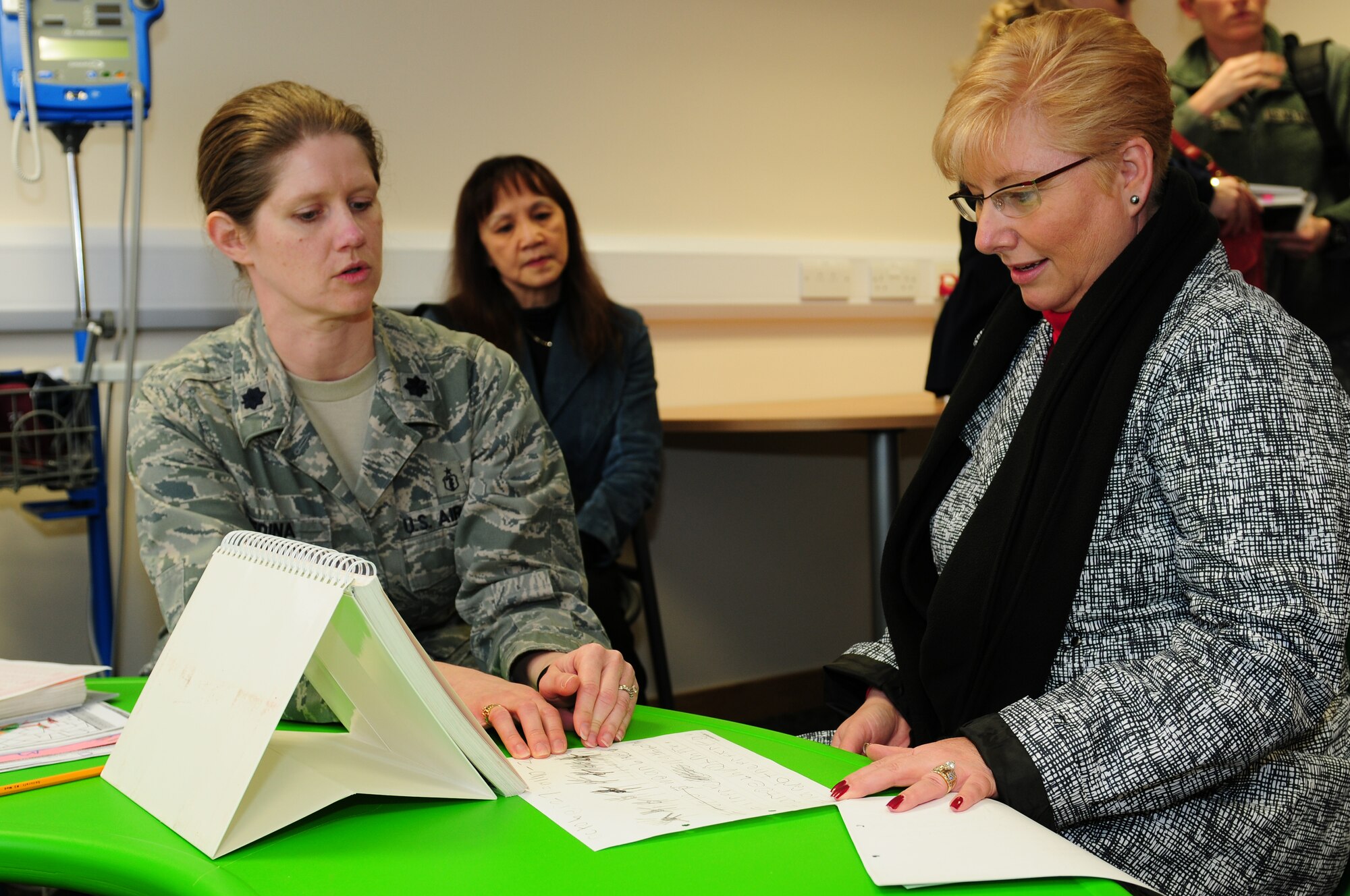 ROYAL AIR FORCE LAKENHEATH, England – Lt. Col. Deanna Medina, 48th Medical Operations Squadron occupational therapist, explains how therapists evaluate children’s needs to Paula Roy, wife of Chief Master Sgt. of the Air Force James Roy, March 13, 2012. Mrs. Roy took a tour of Lakenheath support facilities to see how the 48th Fighter Wing takes care of Airmen and families. (U.S. Air Force photo by Airman 1st Class Cory D. Payne) 