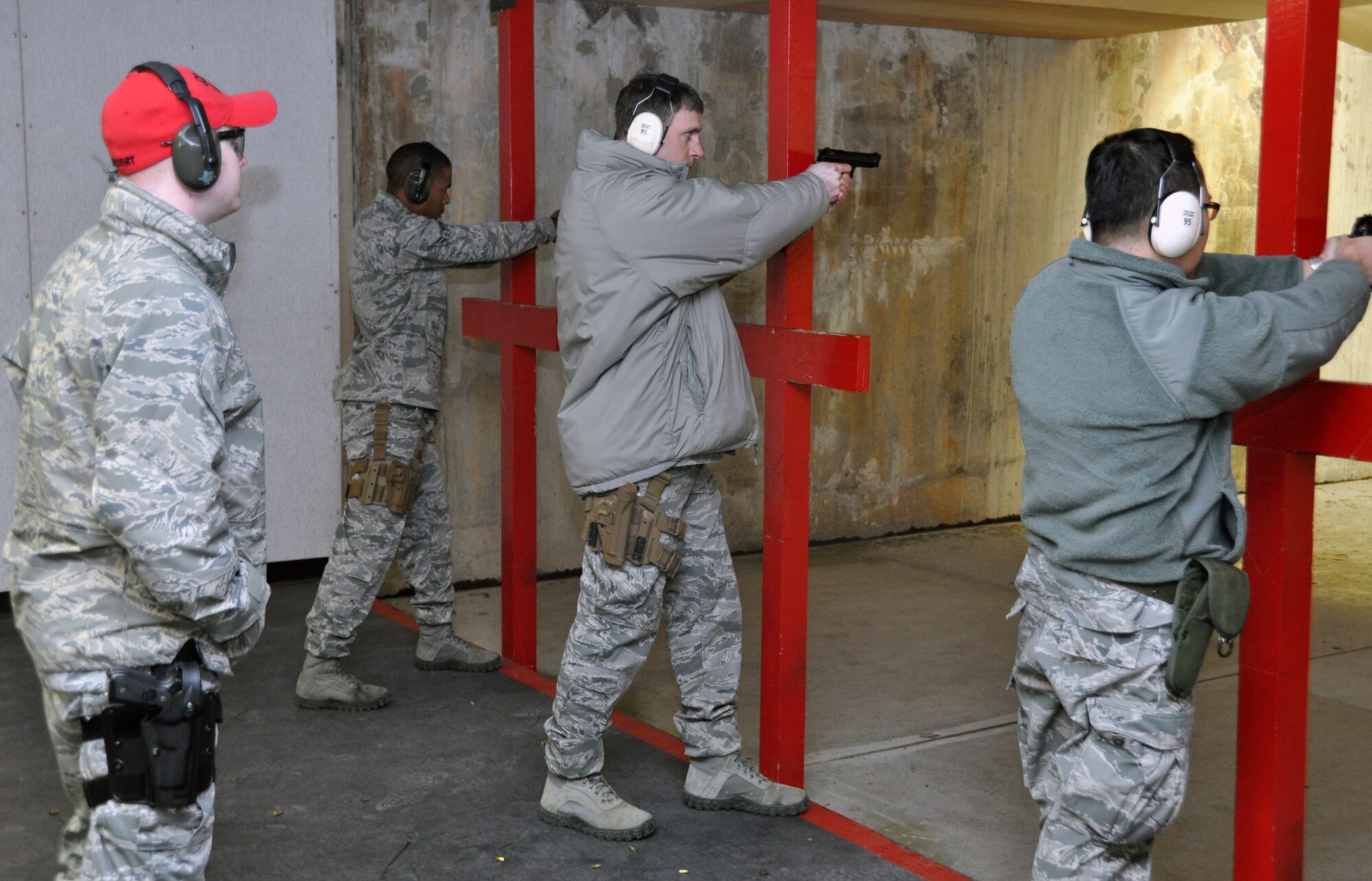 Senior Airman Jonah Stidham, 51st Security Force Squadron combat arms instructor, monitors Airmen on the firing line during an M-9 qualification class at Osan Air Base, Republic of Korea, March 13, 2012. (U.S. Air Force photo/Airman 1st Class Michael Battles)