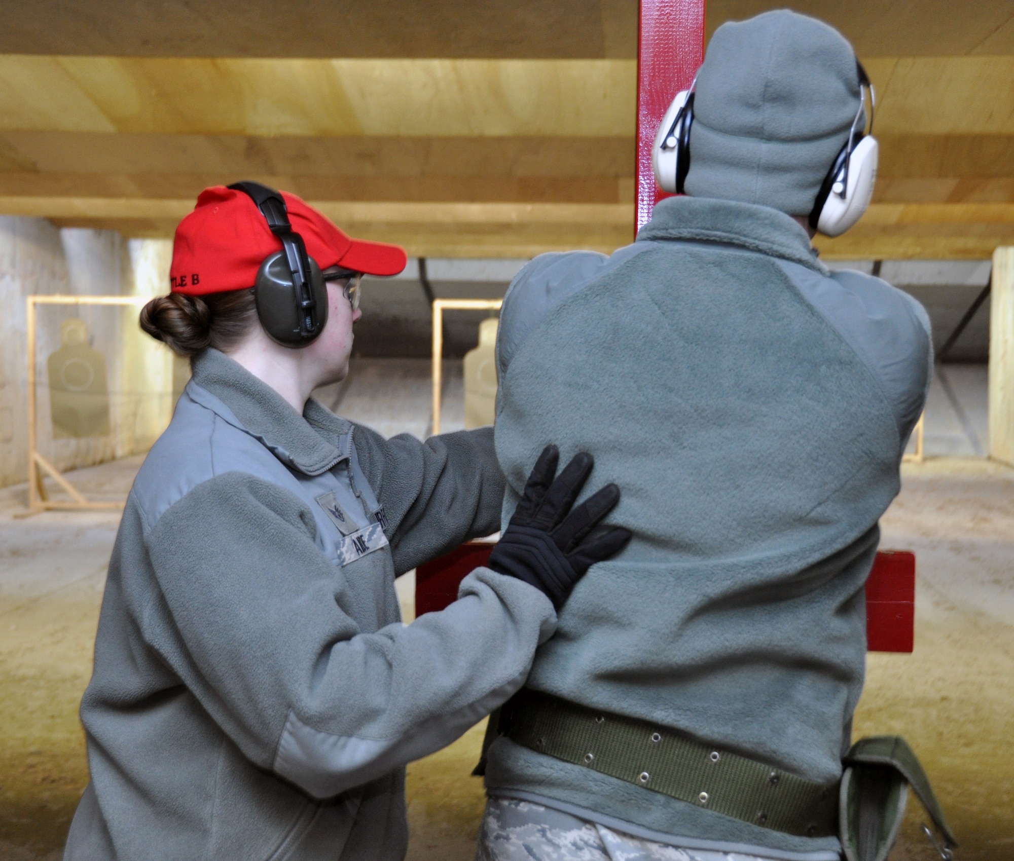 Staff Sgt. Katrina Aide, 51st Security Force Squadron combat arms instructor, teaches an Airman the proper technique for holding a M-9 during a qualification course at Osan Air Base, Republic of Korea, March 13, 2012. (U.S. Air Force photo/Airman 1st Class Michael Battles)