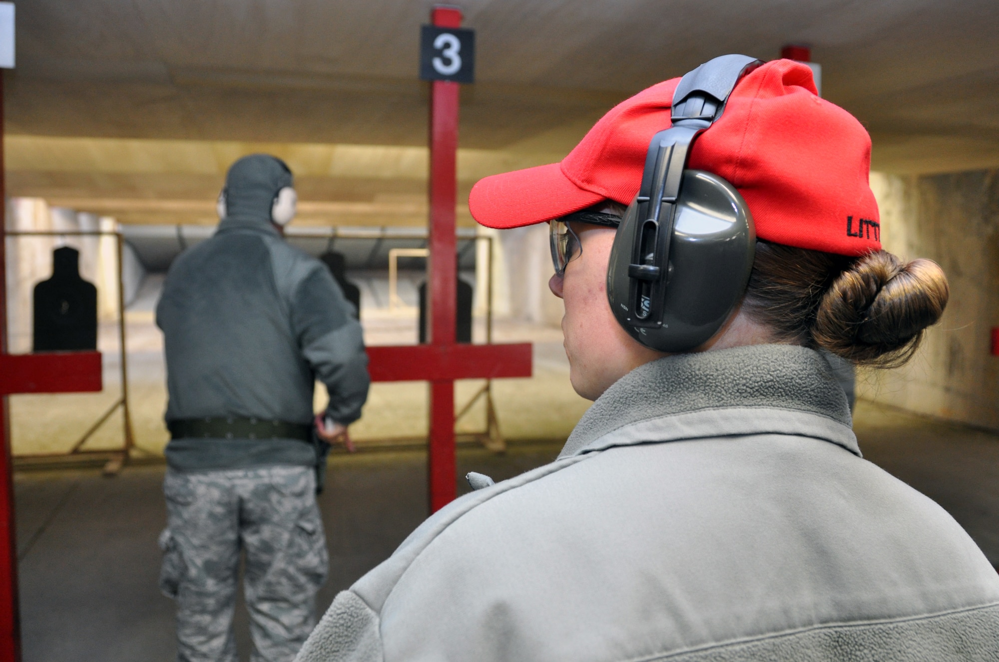 Staff Sgt. Katrina Aide, 51st Security Force Squadron combat arms instructor, monitors Airmen on the firing line during an M-9 qualification class at Osan Air Base, Republic of Korea, March 13, 2012. (U.S. Air Force photo/Airman 1st Class Michael Battles)