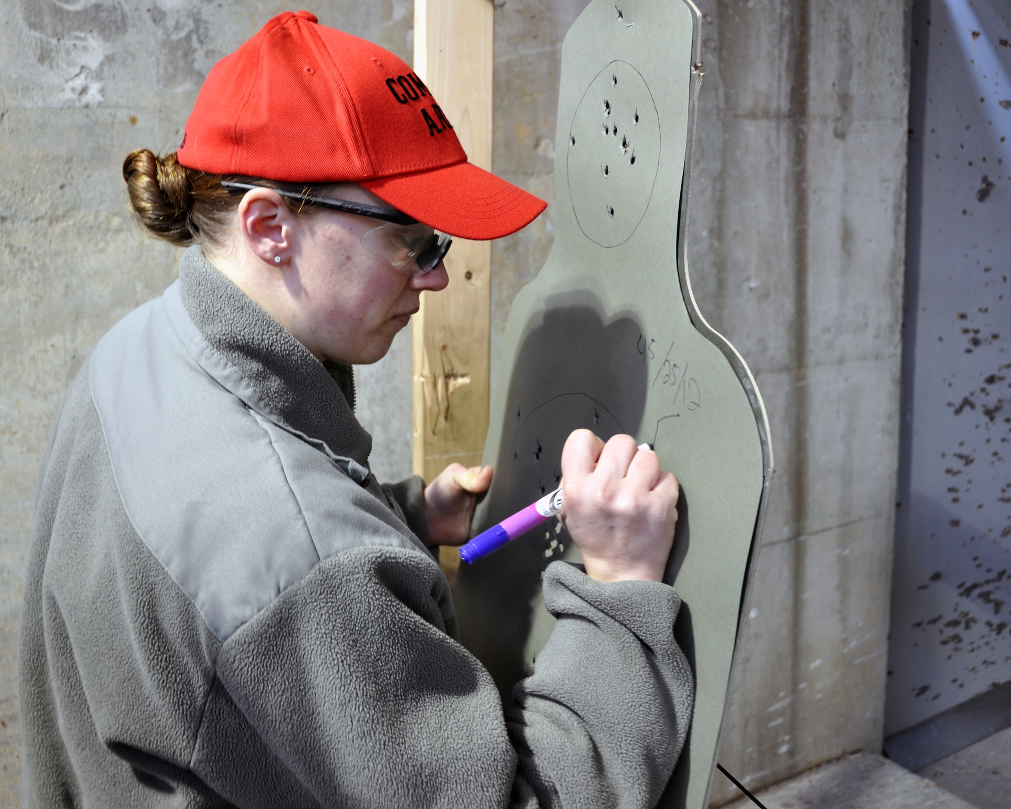 Staff Sgt. Katrina Aide, 51st Security Force Squadron combat arms instructor, scores an Airman’s target after an M-9 qualification class at Osan Air Base, Republic of Korea, March 13, 2012. (U.S. Air Force photo/Airman 1st Class Michael Battles)