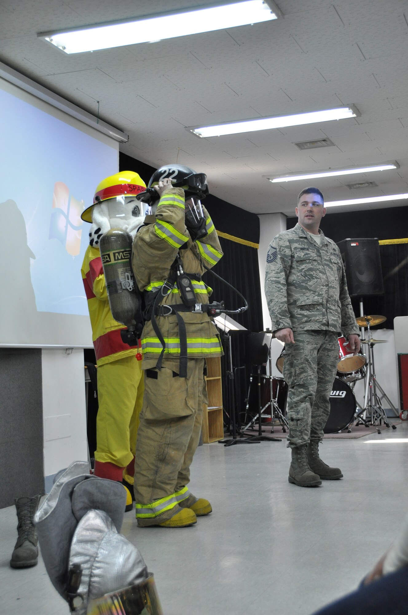 Master Sgt. Joshua Ashton and Airman Chelsea Westfall, both 51st Civil Engineer Squadron firefighters, explain the importance of safety to local Korean student March 9, 2012. (U.S. Air Force photo/ Staff Sgt. Stefanie Torres)