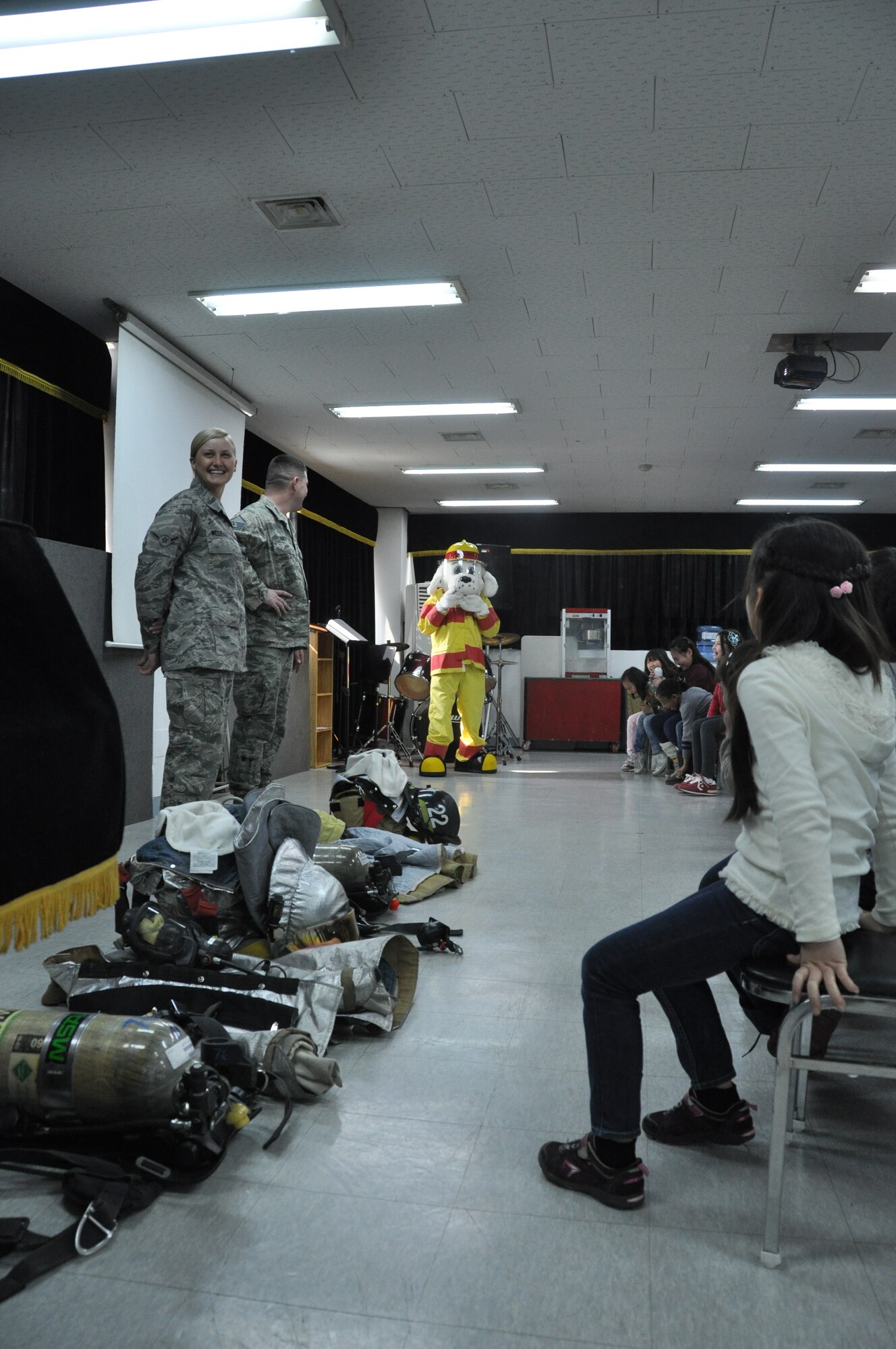 Master Sgt. Joshua Ashton and Airman Chelsea Westfall, 51st Civil Engineer Squadron firefighters, explain the importance of safety to local Korean student March 9, 2012. (U.S. Air Force photo/ Staff Sgt. Stefanie Torres)