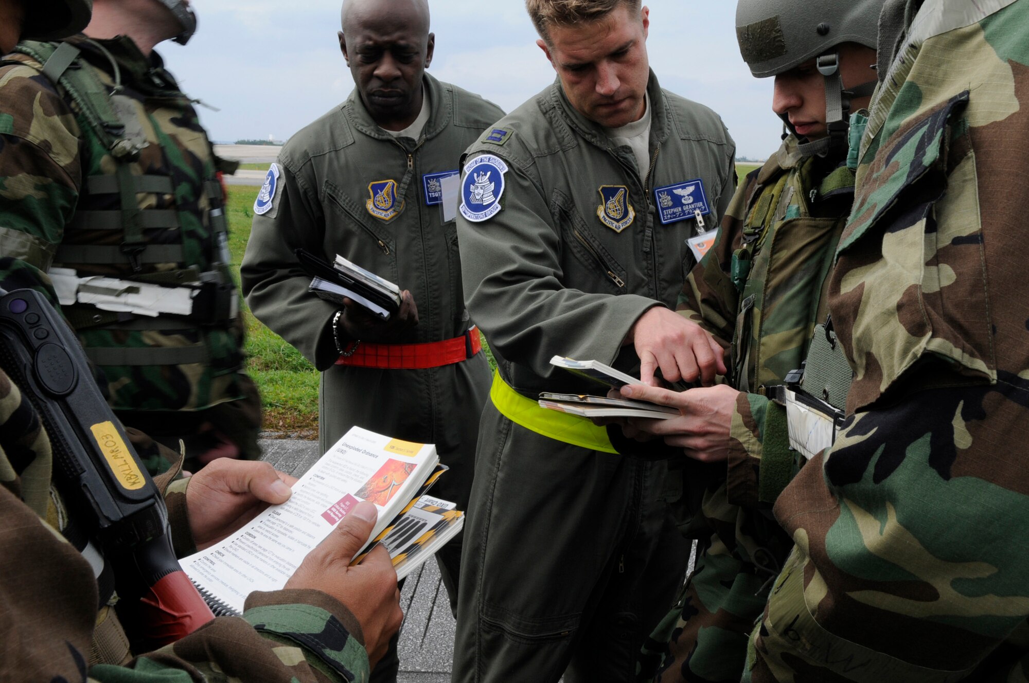 Exercise evaluation team members review a scenario with Airmen from the 33rd Rescue Squadron and let them know what they did right and what they could've done better during a scenario in local operational readiness exercise Beverly High 12-3 on Kadena Air Base, Japan, March 14, 2012. By reviewing the Airman's Manual, Airmen can find the proper procedures for different situations. (U.S. Air Force photo by Airman 1st Class Tara A. Williamson/Released)