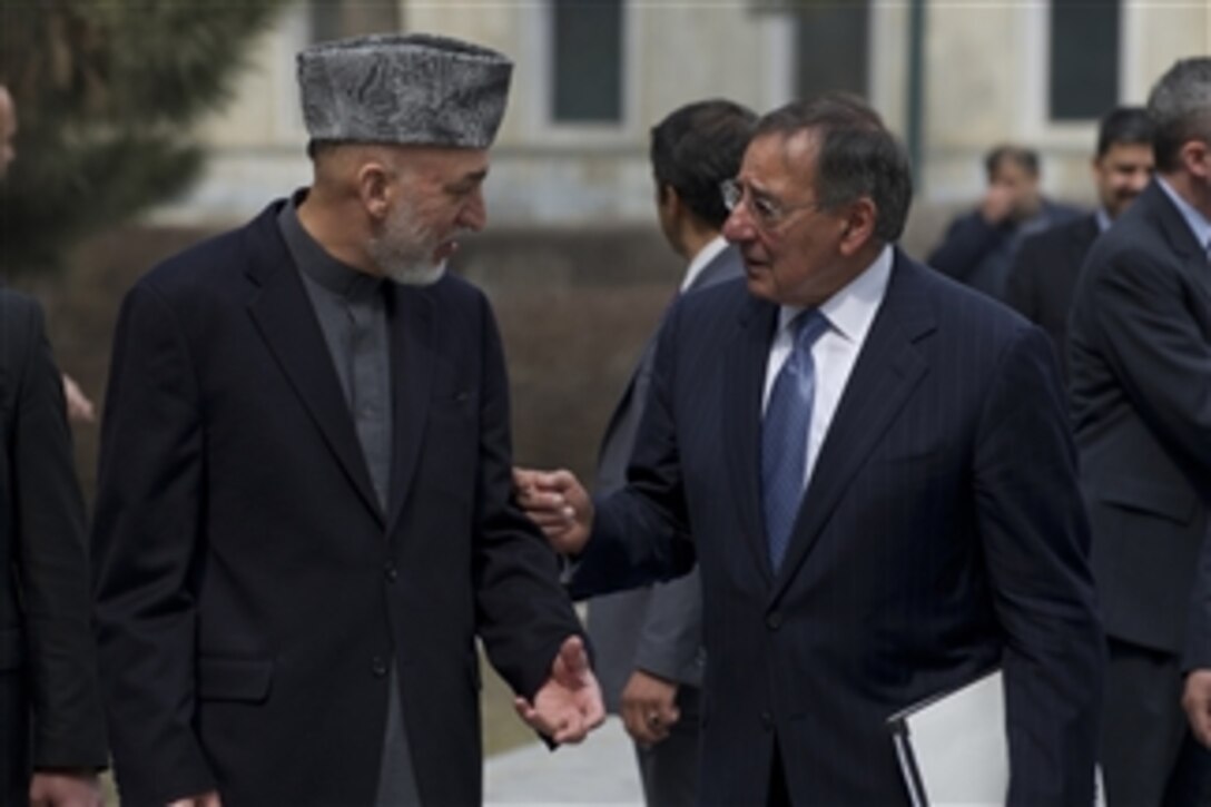 Secretary of Defense Leon E. Panetta speaks with Afghan President Hamid Karzi while walking in Kabul, Afghanistan, on March 15, 2012.  