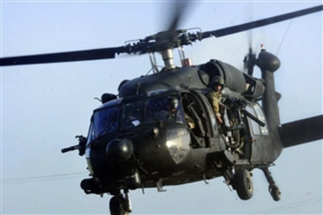 A U.S. Army crew chief observes the horizon from the side door of a UH-60 Black Hawk helicopter as they prepare to land on a helipad at Camp Stehenson, Guyana, during a training event in support of Exercise Fused Response 2012 on March 8, 2012. 