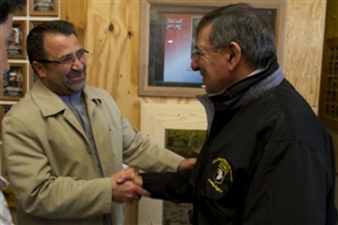 Secretary of Defense Leon E. Panetta is greeted by Helmand provincial governor Gulab Mangal during a visit to Camp Bastion, Afghanistan, on March 14, 2012.  Panetta is on a four-day trip to the region meeting with counterparts, leaders and service members.  