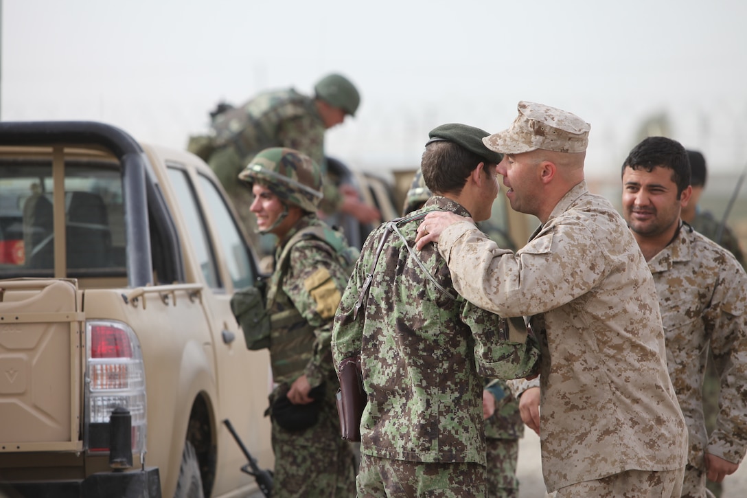 Lt. Col. Luke Kratky, partnering officer-in-charge of Regional Logistics Support Company-Southwest Advisor Team, shakes the hand of an Afghan soldier before RLSC-SW goes off on their first independent, cross-boundary combat logistics patrol at Camp Shorabak, March 15.