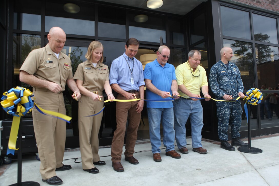 Capt. Daniel J. Zinder, Naval Hospital Camp Lejeune commanding officer, (far left) along with other personnel who helped complete the renovation of NHCL’s galley, cut the ribbon to mark the opening of Doc’s Diner, aboard Marine Corps Base Camp Lejeune, March 16.